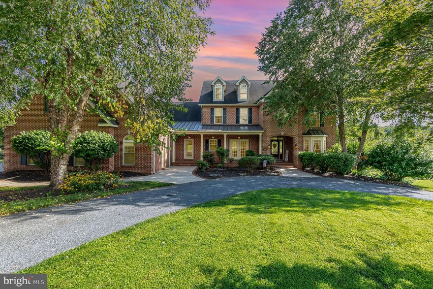 Welcome to this phenomenal 6 bedroom, 5 full and 2 and a half bath home with a 3 car garage on over 7 acres in the secluded neighborhood of Dove Hill Estates in Street, MD.  This home is all brick and boasts over 7300 square foot of luxury living space on 3 levels.  Three decks look out over the 7 acres of green grass followed by woodlands beyond.  The property has a large cleared yard, which then has two wide trails that lead down to a yard beyond the yard in a cleared wooded grove with a stream running through it and wooden bridge, fire pit and woods with four wheeler trails throughout.  There is a large wood shop and a second shed on the property, a paver patio with built in fireplace and farmland and woods in all directions of the rear.  Pull into the circular driveway or park in the three car garage or parking pad and take the walkway to the large covered front porch.  The front door opens into the main level with wood flooring throughout both upper levels, coffered ceilings and luxury trim work throughout.  The main level hosts main level living with an owners suite with its own private deck, walk in closets and large modern bath with double vanities, walk in tiled shower and soaking tub.  The luxury gourmet kitchen features top of the line cabinetry, granite countertops, and large island, custom backsplash and all high end stainless appliances.  There is also a walk in pantry, separate butlers pantry and granite wet bar around the corner between the kitchen and formal dining room.  The kitchen opens into a casual dining area, a sunroom w/ pellet stove, and a living room with tons of windows to enjoy the view and a stone work fireplace that stretches up to the gorgeous coffered ceilings.  Also on the main floor is an open foyer with a deep coat closet, an office, a large laundry room with a tiled pet washing area, and access to the 3 car garage as well as a separate stairwell to the above garage suite.  Taking the stairs to the second floor brings you to a landing overlooking both the foyer and living room with access to the third deck.  The views from this deck are absolutely beautiful.  There are four bedrooms up here and two full modern baths.  One of these bedrooms has a secret access bookcase that pushes open revealing a secret room and hallway that leads to the above garage suite.  Above the garage is a large private bedroom with its own modern bathroom with walk in shower.
Taking the stairs to the basement brings you to a large living space perfect for entertaining, relaxing or play which also includes a full bar custom cabinetry with under lighting,  The basement also houses  a gym , a large bedroom, with a a fifth full bath,  a convenient  powder room and a huge storage/mechanical room which also houses a secret room for storage of valuable items.  French doors off of the rec room lead out onto a large screened paved porch below the deck.
This home is a dream, and has everything you could possibly need, it is pristine, fully updated, the views are astounding and the property is magical!  This is one that needs to be seen in person to be fully understood, make your appointment today!