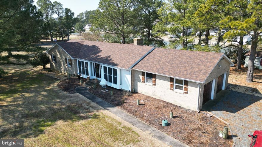 Welcome to this beautifully maintained brick ranch home situated on a canal-front double lot at the end of a quiet cul-de-sac, offering privacy, space, and waterfront living at its finest.
This spacious home features 3 bedrooms, 3 full baths, and 1 half bath, including a huge primary suite with a private en suite bath. The inviting living area showcases a stunning brick fireplace with a woodstove insert, creating the perfect cozy gathering space.  New wood flooring that flows throughout the home, complemented by custom wood blinds and multiple ceiling fans for comfort and style.
The bright and airy sun room is a true highlight, featuring six sliding glass doors with screens that open to a brand-new deck complete with built-in self-watering planters (removable) — ideal for entertaining or relaxing while enjoying serene canal views.
The kitchen was updated in 2022 with new cabinetry, and the home continues to impress with thoughtful upgrades throughout, including: Brand-new roof (2023), New carriage-style garage door with new tracks and Bluetooth-enabled openers with remotes, Screened-in attached patio gazebo, Oversized dock with a private boat ramp, Continuous pest and rodent protection contract with Terminix, Dry-lock system installed under the home (guaranteed by Terminix), Furnace and AC professionally cleaned and serviced annually by Morrow’s, and New attic caps installed in 2025.
The beautifully landscaped yard enhances curb appeal, and the one-and-a-half car garage offers additional storage space. Located in a peaceful neighborhood with a minimal HOA fee of just $75 per year, this property combines modern updates, waterfront amenities, and long-term maintenance care — providing peace of mind for years to come. This exceptional canal-front retreat truly has it all — space, upgrades, and location. Please note that the square footage from the sun room and master is not encluded in the total square footage of the home.