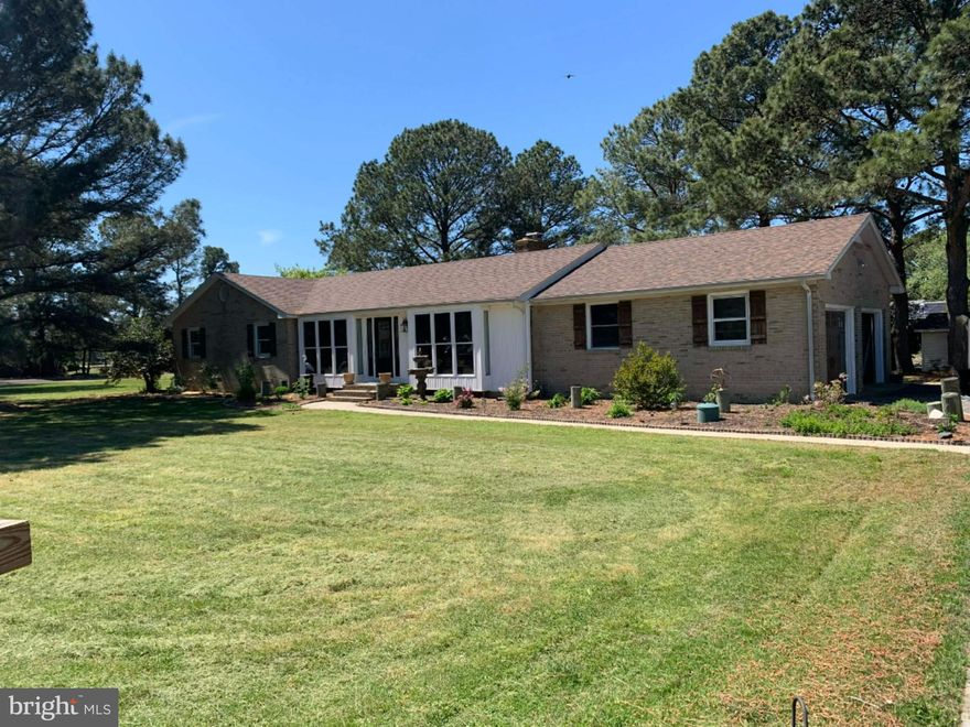 Welcome to this beautifully maintained brick ranch home situated on a canal-front double lot at the end of a quiet cul-de-sac, offering privacy, space, and waterfront living at its finest.
This spacious home features 3 bedrooms, 3 full baths, and 1 half bath, including a huge primary suite with a private en suite bath. The inviting living area showcases a stunning brick fireplace with a woodstove insert, creating the perfect cozy gathering space.  New wood flooring that flows throughout the home, complemented by custom wood blinds and multiple ceiling fans for comfort and style.
The bright and airy sun room is a true highlight, featuring six sliding glass doors with screens that open to a brand-new deck complete with built-in self-watering planters (removable) — ideal for entertaining or relaxing while enjoying serene canal views.
The kitchen was updated in 2022 with new cabinetry, and the home continues to impress with thoughtful upgrades throughout, including: Brand-new roof (2023), New carriage-style garage door with new tracks and Bluetooth-enabled openers with remotes, Screened-in attached patio gazebo, Oversized dock with a private boat ramp, Continuous pest and rodent protection contract with Terminix, Dry-lock system installed under the home (guaranteed by Terminix), Furnace and AC professionally cleaned and serviced annually by Morrow’s, and New attic caps installed in 2025.
The beautifully landscaped yard enhances curb appeal, and the one-and-a-half car garage offers additional storage space. Located in a peaceful neighborhood with a minimal HOA fee of just $75 per year, this property combines modern updates, waterfront amenities, and long-term maintenance care — providing peace of mind for years to come. This exceptional canal-front retreat truly has it all — space, upgrades, and location. Please note that the square footage from the sun room and master is not encluded in the total square footage of the home.