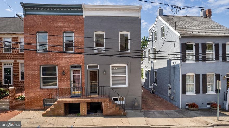 Beautifully updated and maintained semi-detached TH 2 blocks from the Carroll Creek Promenade and walkable to all downtown Frederick attractions. Off street alley parking adds to the appeal while backing to the MSD campus with direct views of the Hessian Barraks surround the home with history and beauty. A leafy walled garden adds an element of tranquility and calm to this urban environment, while just steps from a lively downtown environment. An eat-in kitchen with granite countertops and NEW SS  appliances opens to a glassed-in porch room perfect for entertaining or lounging. Enjoy dedicated living and dining spaces, a main level guest powder room, and an upstairs bath with separate shower and soaking tub, a huge walk-in closet, and light-filled interiors with side windows. A full basement offers laundry, inside access and both rear garden and street access. NEW gas furnace 2015!