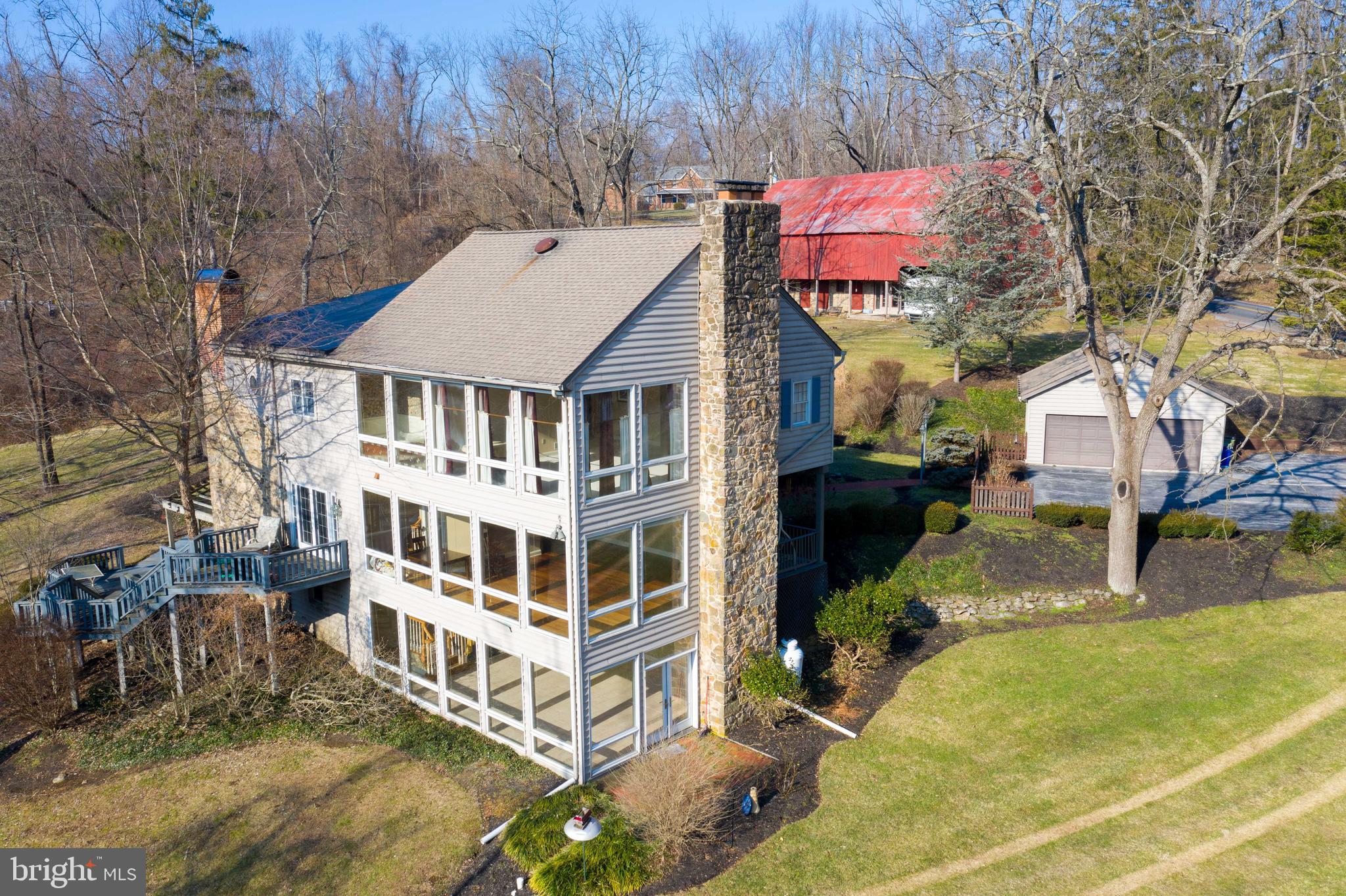 Once in a lifetime opportunity to own this 5.6 acre wooded estate boasting over 5000 sq ft of finished living space featuring a detached garage, barn and awesome views from every floor. This historic home offers many of its original charm and character to include; wide plank wood flooring, deep window sills, 4 fireplaces and exposed wood ceiling beams. Formerly, Blair Mountain Bed & Breakfast this home offers 5 bedrooms, 2 with private en-suite bathrooms, 5.5 total bathrooms and plenty of room to spread out and enjoy the peaceful surroundings. The main level features a spacious kitchen with large center island, stone accent wall, separate butler's pantry, French doors leading out the rear deck and all appliances. Large breakfast room with built in hutch and stone fireplace is the perfect spot to gather for your first meal of the day. Separate formal dining room is ideal for those special family gatherings. Enjoy entertaining in the expansive family room with wood burning fireplace and 7 sets of floor to ceiling windows where you can enjoy the views. At the end of a long day enjoy retiring to the large  2nd floor master suite featuring a wood burning fireplace, large walk in closet, private en-suite bathroom and 5 sets of floor to ceiling windows to enjoy the sunsets. An additional nice sized bedroom can also be found on the 2nd floor along with a full bath and laundry room. As you journey to the 3rd floor you will discover 2 additional bedrooms, one with a full en-suite bathroom plus another full bath with jetted tub. The lower level offers a 2nd family room with gas fireplace, floor to ceiling windows, plus an additional full bath and bedroom. Outside amenities include; a detached 2 car garage, large barn, 2 covered front porches, brick walkways, 2 tier deck, pond and patio with pergola. Located only minutes from Ski Round Top and Chestnut Community Park. If you are looking for your own personal retreat, this is definitely the home for you. Come check out the beautiful views and all this wonderful homes has to offer.