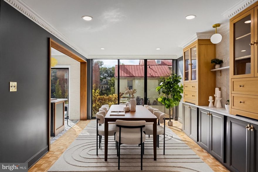 Welcome to this exquisitely reimagined residence in Society Hill, originally designed by Louis Sauer and thoughtfully renovated to offer the perfect balance of modern luxury and timeless character. This four-bedroom, three-bath home with private parking showcases elevated craftsmanship and refined finishes throughout.



As you enter the foyer, you’re greeted by a bright and expansive living area featuring 11-foot ceilings, classic mill work, intricate custom moldings, a marble-surround fireplace, and beautifully preserved parquet oak floors. Floor-to-ceiling windows flood the space with natural light and frame serene views of the tree-lined street. Just beyond the living room, a patio overlooks the lushly landscaped gardens, creating an inviting space for morning coffee or evening relaxation.



The gourmet kitchen is a showpiece of design, appointed with premium stainless steel appliances, inset cabinetry, Carrara marble countertops, and a custom-tiled range hood. An adjacent dining area with custome built-in shelving and cabinetry provides a warm and elegant setting for entertaining.



Upstairs, the tranquil primary suite offers a generous walk-in closet and a spa-like bathroom featuring a walk-in shower and a freestanding soaking tub. Two additional bedrooms and a full hallway bath complete this level, blending comfort with thoughtful design.



The lower level is equally impressive, offering a spacious bonus room with over-sized windows overlooking the rear patio and garden—perfect for a media lounge or entertaining space. This level also includes a mudroom/bar area and an additional full bathroom for convenience.



A gated parking space directly behind the home provides ease and functionality in this coveted neighborhood. Nestled in the heart of a historically preserved community, residents enjoy access to beautiful green spaces like Three Bears Park and Independence Park. All of this, just steps from acclaimed restaurants, charming cafés, Ritz and PFS theaters, and a short 15-minute drive to the airport.