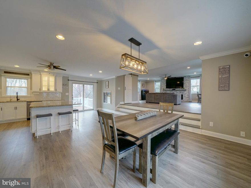 Don't miss this unique home with many updates and upgrades featuring custom built ins and open floor plan concept. Major remodeling over the past 10 years have created a quality home with so many extras, that you have to see it in person to appreciate the amenities. Located on just over an acre of landscaped grounds with mature trees and shrubbery. The extremely large driveway is perfect for multiple vehicles, including room for recreational vehicles/boats, and has a stamped concrete walkway(2021). No Hoa! Inside the 2 story entry foyer addition (2020) has created a perfect landing station with built in benches/storage cabinets on both sides, with shiplap walls. Upper level has spacious open living areas with modern kitchen, breakfast bar island, updated SS appliances, open to dining area with full wall of built in cabinets and counter. Up a few steps to the addition, added in 2020, the great room features large open/airy living space with an electric/led fireplace with stone wall and mantle as the center focal point. Plenty of room for entertaining or family get togethers. Built ins include bar with wine and glass shelves. The huge walk in pantry has built in shelving, led lighting and plenty of electric outlets, perfect for a beverage bar in addition to storage. Off the kitchen are 2 beverage coolers built into the wall for easy access. The composite deck is off the kitchen and has stairs down to the stamped concrete patios. The bedrooms are 3 up and 1 down with 3 full baths all have been remodeled and updated with tile and vanities. The primary bedroom features a full wall of built ins behind the sliding barn doors and an en suite full bath remodeled in 2020, with heated floors, bidet and oversized shower with tiled walls, rock floor and spa water features including rain showerhead. The lower level 4th bedroom has numerous closets including a walk in cedar closet, 2 double clothes closets and 2 double storage closets with shelves. Laundry room has plenty of storage space, a full size washer, dryer and a utility sink. 2nd family room or rec room has storage closets and daylight windows. Rear exit to patios from the rec room. The home has 2 levels of living space, could be perfect for generational shared living. The 2 car garage has been temporarily converted to a daycare room with a half bath and rear exit. The seller does not plan to convert it back, but the new owners may want to or use the space for a home office, hobby room or great indoor gym. There are 2 mini splits in addition to the main HVAC, one in the converted garage and the other in the great room. Outside the yard has been utilized for enjoyment with a hot tub on the patio, built in firepit in the yard, playset in the rear and huge shed on the side yard. On over 1 acre there is still room for future owners outdoor living space ideas. This community is a well blended mix of new and older homes. Minutes to Rt 26 and Rt 32, convenient to the Sykesville Historic district or the shopping in Eldersburg and Westminster. Sykesville Carroll County is a wonderful community with historic downtown and many shopping strips with a variety of choices for casual or fine dining. It's all here!