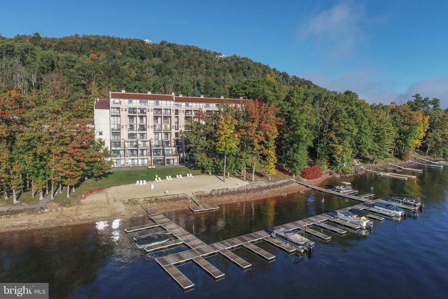 Lakefront living at it's best can be found in this completely renovated spacious condo. This three-level unit is the perfect place to get away together! With space to come together and space to escape, this unit promises both privacy and togetherness for a memorable Deep Creek Lake experience! The first level has a full kitchen with wine fridge and attached living room with an electric fireplace, queen sleeper sofa, high top table with stools and a breathtaking balcony. Just up the stairs, enjoy the king bed in a loft bedroom that overlooks the living room and towering two-story window facing Deep Creek Lake! Also on this level is another bedroom with a Queen bed that shares a hallway bathroom with luxury finishes and a walk-in shower.

On the top level you will enjoy even more space and accommodations. The 7th floor level has an additional hallway entrance for more privacy. Relax in the King bed and look out to your private balcony with gorgeous lake views. This space also features a well appointed luxury bathroom with walk-in shower and double bowl sinks. An additional mini-fridge and Keurig coffee maker provide easy access if you don't want to go downstairs. Up above in the vaulted loft curl up in the Queen size bed and take in panoramic sunrise views from every angle.

Head down to the sandy beach to watch the water gently roll along the sandy shore of the resort’s private beachfront.  No matter the season, there is plenty to keep you entertained with an on-site indoor pool, game room, fitness center, and more! RAILEY REALTY IS NOT THE CARETAKER OF PROPERTIES LISTED BY IT. DURING INCLEMENT WEATHER CONDITIONS, PROSPECTIVE PURCHASERS AND THEIR AGENTS ASSUME ALL LIABILITY ASSOCIATED WITH OR BY WEATHER AT THE PROPERTY.