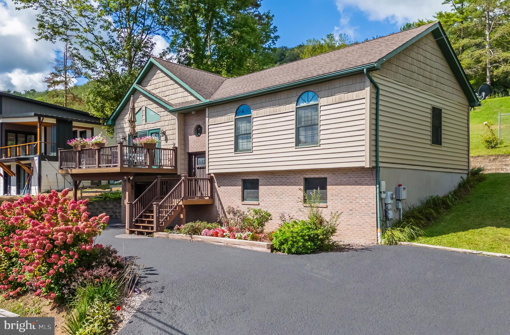 Nestled in the heart of McHenry, this well-maintained split-level home offers the perfect blend of modern comfort and serene mountain living. Offering filtered views of Deep Creek Lake and the luxury of Wisp in your backyard. The spacious, open floorplan lends to an inviting atmosphere, with large windows flooding the home with natural light. The updated kitchen has a large island, granite countertops, stainless steel appliances, and ample cabinet space—ideal for preparing meals and entertaining guests. Outside, the beautifully landscaped yard and spacious deck offer perfect spots to enjoy family and friends. And the roomy rear covered porch provides you with one of the best views to watch the fireworks over Wisp Mountain. The property is ideally located just minutes from Deep Creek Lake and Wisp Ski Resort. Whether you’re looking for a weekend getaway, a full-time residence, or an investment property, this is the perfect choice. Don’t miss out, call today for a showing!