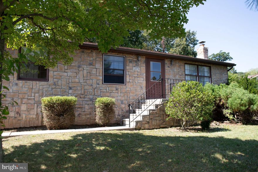 Welcome to this charming stone-front home on  in the Cresaptown/Cumberland area, offering three bedrooms, one full bath, and two half baths. Thoughtful design details and inviting spaces make this home both comfortable and functional.

The main level features a light-filled breakfast nook and an enclosed sunroom—the perfect spot to enjoy your morning coffee or relax year-round. The layout flows easily between living, dining, and kitchen areas, while the backyard provides plenty of space for outdoor activities.

Downstairs, the full basement is ideal for entertaining, complete with a wet bar, woodstove, and direct walkout access to the driveway. The side-load garage includes a built-in workbench, adding both storage and workspace for hobbies or projects.

Conveniently located near major routes, shopping, dining, and everyday essentials, this home offers both comfort and accessibility. Schedule your tour today!