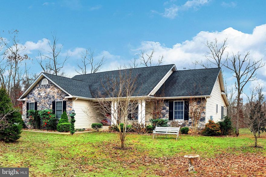 Fabulous 5 acre property with custom built 5 bedroom home in serene but very convenient location. Open flowing floor plan with large living area and 3 bedrooms on main level. Fully finished garage. Southern style porch in back overlooking gorgeously landscaped lot. Spacious lower level can be a separate 2 bedroom  apartment.