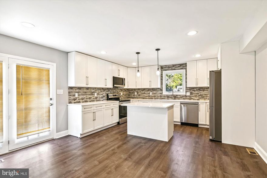 Welcome Home to this beautiful Modern tri-level brick home on a large  lot.This home has so much to offer. Main level includes a living room & Dinning room, a Gorgeous almost  brand new kitchen with New high end appliances, Granite counter tops, Kitchen Island a separate dining room, Also separate  formal dining room w/ sliding door out to  a nice size deck. The First level has 3 bedrooms and 1 full Renovated bath. The Newly remodeled lower level has one bedroom, a flex area with a walkout to the rear also  a full bath and a recreation room ideal for gatherings or hang out! Upper level offers an enormous Master Bedroom and Renovated bath with huge walk-in closet. In addition this property has many  updates such has, new interior doors, new painting, New carpet , new floors, new light fixtures, new bath fixtures, new sliding doors and list goes on!.This home is Close to plenty of shopping & access to Rt 97 & 695 for your commute! All you have to do is move-in and start enjoying! Schedule your showing and bring us your best offer!