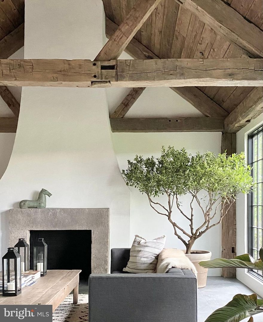 Reimagined in a daring display of natural beauty, Greenhill Farm is a modern-day retreat that elevates the standard for sophisticated country living.  Surrounded by open fields and mature trees, Greenhill Farm is a project focused on the use of authentic materials while emphasizing stylistic sight lines. Luxury home specialists Patrick Pastella and Kanitha Burns of PASTELLA | BURNS sought to create Greenhill Farm, their private Solebury residence, into a home that unifies the original homes purist form with modern additions showcasing uncompromising interiors.  The design and building approach went unrestricted and emphasizes the juxtaposition of old vs new and raw vs refined.  Distinctive features of Greenhill Farm include the use of highly distressed wood, shadow line walls, large format porcelain and customized adobe plastering techniques throughout the homes interior.  The designer kitchen is entirely customized with a 16’ island.  Over 11 slabs of granite weighing nearly 7,000lbs were used to create the kitchen’s designer features and stone mitered ends.  The porcelain floors extend across the home with radiant heat throughout.  The vanities are all designer pieces from Barcelona, Spain.  Fixtures utilized include luxury brands such as Dorn Bracht, Badeloft and BOCCI to name a few. The main residence consists of over 6,100 square feet of interior space with two additional guest houses and studio building.  The property also boasts a large timber framed barn from the 1850’s.  Lose yourself walking the property’s forrest and meadow trails.  Greenhill Farm is stately, sexy and a master class in what is possible in a luxury home.  To the core, this home is a country-side retreat fit for  decerning homeowners seeking an escape from the rigors of daily life