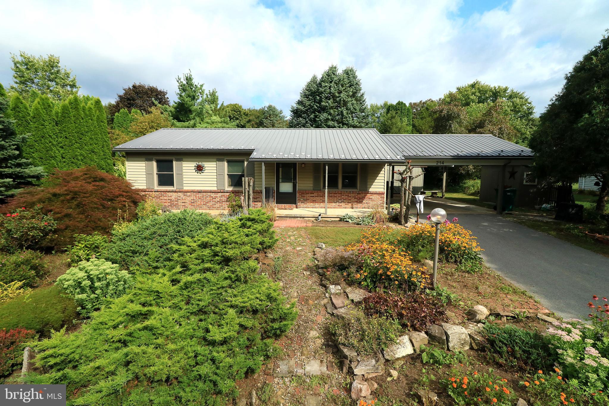 Heartwarming ranch nuzzled in the sought-after Pleasant Hills neighborhood, where eye-catching curb appeal & extensive landscaping set the tone for comfort & charm. The cozy covered front porch invites you to sit back & soak in breathtaking mountain views offering you your daily dose of serenity. Inside, the spacious living room features luxury vinyl plank flooring & an open layout. Originally a 3-bedroom home, the owner thoughtfully removed a wall to expand the living space, though it could easily be converted back to a third bedroom if desired. The bright & cheerful eat-in kitchen comes fully equipped with included appliances to include a gas stove, making meal prep a breeze. Two bedrooms & a full bathroom complete the main level, while the full unfinished basement offers so much potential with ample storage & potential for additional living space. Bilco stairs provide convenient exterior access & the laundry area includes a washer and dryer. Savor your morning coffee or unwind with an evening cocktail on the patio, overlooking the serene, tree-lined backyard. Additional highlights include Central Air for year-round comfort, electric baseboard heat, 12x16 Amish-built shed (2023), a garden shed, Renewal by Andersen replacement windows (front-facing only, 2023), metal roof & added an attached 20x24 carport (approx. 2020). Located near Pleasant Hills Park, just minutes from the elementary school, local dining favorites, shopping & historic downtown Bellefonte, with easy access to I-99 for a smooth commute to State College and Penn State University. Whether you're starting out or looking to downsize, this lovingly maintained home is ready for your next chapter.