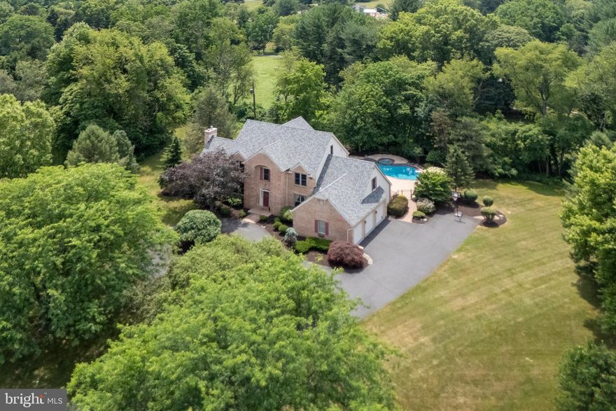 This magnificent home features a brick exterior, circular drive, & CUL-DE-SAC setting on ONE ACRE in desirable Saucon Valley. 6-bedrooms, 4 full + 2 half baths, and more than 5,000 sqft of thoughtfully designed living area creates a perfect blend of SPACE, COMFORT, & FUNCTIONALITY. A welcoming 2-STORY FOYER leads to an OPEN FLOOR PLAN w/high ceilings, pocket doors & a wall of windows overlooking the professionally landscaped pool area. At the heart of the main level is a beautifully appointed kitchen, eat-in area & great room w/STACKED STONE WALL & FP, all leading to the paver patio & delightful SALTWATER POOL w/spa. The generously proportioned family room features a fireplace, vaulted ceiling, & wet bar. The 1st floor also has a cozy study w/built-in bookcases. A back foyer offers access to the 3-CAR GARAGE, laundry & 2nd powder room w/convenient pool access. The 2ND FLOOR PRIMARY SUITE offers plenty of privacy, vaulted ceiling, gas FP, large windows & private balcony overlooking the pool & serene backyard. The luxurious bath has skylights, radiant heat floors, spa tub, STEAM SHOWER & 2nd shower. Four more bedrooms plus 2 full hall baths complete the 2nd level. A bright & spacious en suite bedroom w/skylights & built-ins occupies the 3RD LEVEL, offering a private retreat at the top of the home. In addition, the FINISHED LOWER LEVEL is ideal for home gym, kids play space, etc. EASY ACCESS to everything, including top-rated schools, Saucon Valley CC, shopping, dining & more!