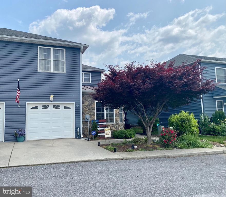 Absolutely beautiful, cottage-style end unit townhome located in Woodstock. Natural light fills the home with sunshine. Mountain and farm views. Great location that is convenient to schools, shopping, and all of the amenities that Woodstock has to offer. The home is nicely landscaped and features a fenced-in backyard, ready for children and pets. Storage building in the back yard also conveys. Entering the main level you are welcomed by a large family/living room with a fireplace, moving into the kitchen is a breakfast nook and a connecting separate dining room. The primary bedroom with a fireplace, full bath, laundry area, and walk-in closet is also on the main level. Enjoy evenings on your porch which has a screened section as well as an open section. Upstairs there are two additional bedrooms, a sitting room with a fireplace, a full bath, and a second laundry area. This updated and well-maintained townhouse could be your new home!  Owner/agent related. Call to schedule your showing today!