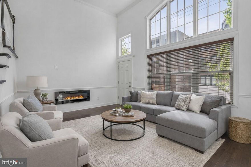 Welcome to this exceptional home in the sought-after Liberty Greene community in Northern Liberties, complete with coveted garage parking. This striking residence blends classic brick frontage with modern, sophisticated design. Step inside to a dramatic living room featuring soaring 14-foot ceilings and abundant natural light. A short flight of stairs leads to the dining area and kitchen, thoughtfully positioned to overlook the living space—offering both an open-concept feel and defined living areas. The kitchen provides access to a private balcony, perfect for grilling and entertaining. The second floor includes two generously sized bedrooms, a full hall bath, and convenient laundry. The entire third level is dedicated to an expansive owner’s suite with a spa-inspired bath, two oversized walk-in closets, and a private balcony showcasing sweeping city views. A fully finished basement adds flexible living space, and the unbeatable location places you just steps from Liberty Lands Park, Liberties Walk, and an array of popular cafes, restaurants, and neighborhood amenities. This is a rare opportunity to own a beautifully designed home in the heart of Northern Liberties. Taxes and square footage is the responsibility of the buyer to have verified independently.
