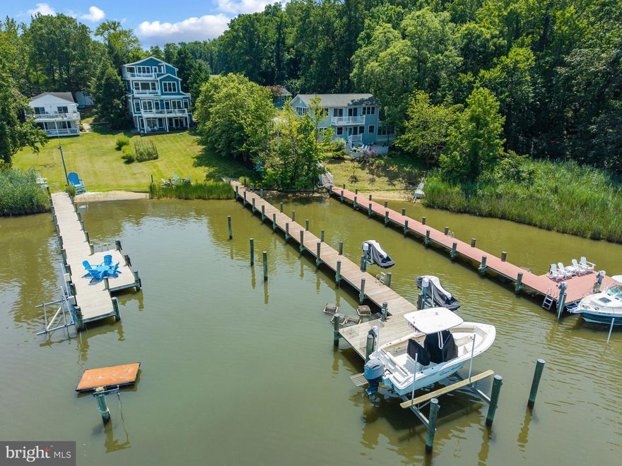 Live the Chesapeake Bay lifestyle from this thoughtfully designed 5-bedroom, 4.5-bath waterfront home on Ramsey Lake, offering sweeping views of Selby Bay and the South River. 

The open-concept layout is perfect for both everyday living and entertaining, with a covered front porch, expansive rear deck, and a finished walk-out lower level complete with a full bath, second kitchen, and flexible space ideal for a gym, media room, or studio. The gourmet kitchen features a gas cooktop with hood, granite counters, stainless appliances, tile backsplash, soft-close cabinetry, a large eat-in island, and a butler’s pantry with wine storage. The living room showcases coffered ceilings, recessed lighting, and a gas fireplace with water views beyond. The spacious primary suite includes a private deck, two walk-in closets with custom built-ins, and a spa-like bath with jetted tub and steam shower. A water-view bedroom/office with its own balcony offers the perfect work-from-home retreat. 

Outside, enjoy evenings around the firepit or head to your private pier with deep water, a boat lift, and two jet ski lifts. With hardwood floors throughout, built-in speakers, a mudroom with custom storage, an oversized two-car garage, and a generator for peace of mind, this home offers the very best of waterfront living in Edgewater.