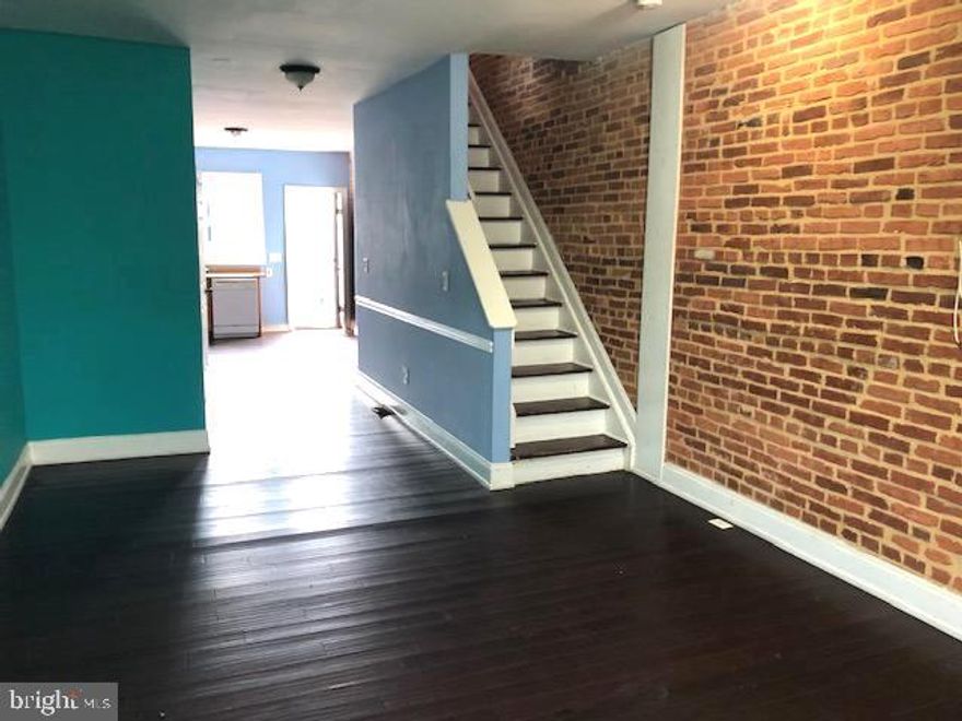 GREAT OPPORTUNITY TO OWN THIS SPACIOUS PATTERSON PARK ROWHOME WITH 3 FINISHED LEVELS AND POTENTIAL FOR PARKING!  Property does need some work but also has great potential.  Main level has an open floor plan with wood laminate flooring, exposed brick, spacious kitchen, and a half bath.  The upper level has 2 bedrooms - 1 with a walk-in closet, and a full bath.  The basement is partially finished with a finished room that could be used as a third bedroom.  The rear yard is currently fenced with a privacy fence but could easily be converted to a parking pad.  Property is conveniently located close to Patterson Park and Johns Hopkins Hospital!  Sold As-Is!