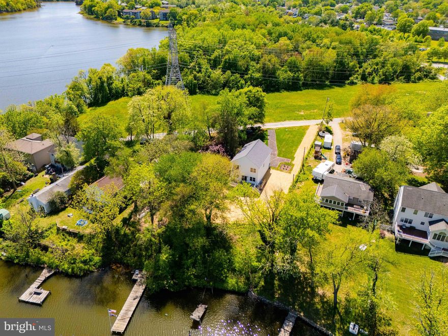 Significant price improvement on this rare opportunity to own a newly built waterfront home on Marley Creek, set on nearly half an acre with wide water views and a level, usable yard. It is difficult to find this combination of newer construction, land, and waterfront lifestyle at this price point.

Natural light fills the main level through expansive rear windows that keep the focus on the water. The layout flows seamlessly from the living area into the kitchen and out to the backyard, creating an ideal setup for both everyday living and entertaining.

Upstairs offers four true bedrooms, including a spacious primary suite with water views. The full-height walkout basement provides excellent flexibility for future living space, recreation, storage, or a home gym and is already roughed in for a future bathroom.

The outdoor setting is what truly sets this property apart. The large yard offers space to expand outdoor living and fully enjoy the waterfront surroundings. As an added bonus, the builder has secured a pier permit that will convey with the property, allowing the next owner to customize their waterfront setup. Estimated water depth at the future pier location is approximately 8 to 10 feet, buyer to verify.

Quietly tucked away while still convenient to major commuter routes, this is a rare chance to own a move-in ready waterfront home with room to grow and make it your own over time.