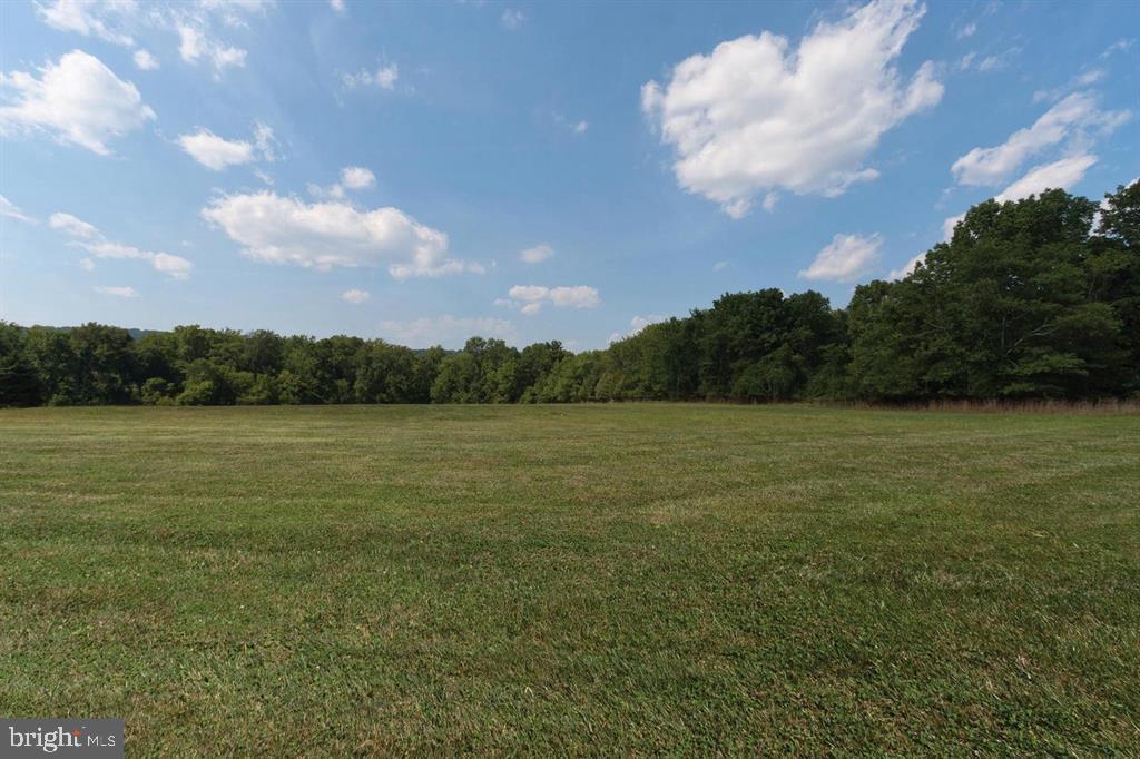 Please do not enter property without appointment being confirmed. Do not Drive on any of the grass please.
This is your chance to build your dream property!
Discover your sanctuary in Solebury Township, a stone's throw from the vibrant culture and shopping of New Hope, PA. Nestled in a serene flag lot, this property offers an oasis of tranquility with its open, rolling landscapes edged by a forest of mature trees. Imagine the Pidcock Creek winding through these woods, adding a picturesque backdrop to your future home. Your everyday journey could include a drive through the quaint, historic Van Sant covered bridge, adding a touch of charm to your routine.
The area is a haven for outdoor enthusiasts and culture seekers alike. Cycle to Bowman's Hill Wildflower Preserve, jog along the canal towpath, or engage in fishing, kayaking, or boating on the Delaware River. The Historical Washington Crossing State Park is just minutes away, perfect for a day of exploration. When the mood strikes for dining and shopping, New Hope and Lambertville are a short drive away, offering an array of restaurants, boutiques, and the renowned Bucks County Playhouse.
This ready-to-build lot comes with a well already installed. Though the septic permit has expired, it is renewable, ensuring ease in starting your building project. Available to you are a plot plan and building designs. The lot is part of a shared driveway arrangement with a neighboring property, featuring a stunning custom tidewater cape style home by Lynn Taylor and built by Jarrett-Vaughn. Property is presently under Act 319, and the property cannot be further subdivided, preserving its exclusive appeal. DRIVEWAY Entrance is shared, then splits at the top of the lot. DO NOT DRIVE ON ANY OF THE GRASS PLEASE