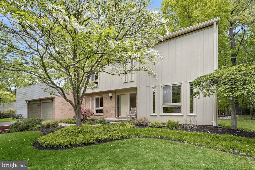 Impeccably updated and beautifully expanded, 8605 Hidden Hill Lane is a perfectly appointed mid-century modern home located in the coveted East Gate of Potomac neighborhood. This enviable home boasts 4 bedrooms and 3.5 bathrooms across 3 levels, cathedral ceilings, gleaming hardwood flooring and walls of windows bringing abundant natural light into the home’s interiors. The Main Level boasts a seamless balance of formal and relaxed living spaces and provides idyllic settings for large-scale entertaining or more intimate gatherings. The entry Foyer is flanked by the formal Living and Dining Rooms and provides a warm welcome to the residence. The expanded and reimagined Gourmet Kitchen is designed for the discerning chef and is fully equipped with top-of-the-line appliances, including Kitchen Aid double ovens and a Thermador gas range. Recessed and under-cabinet lighting enhance the warm, inviting atmosphere, while the dual pantries provide ample storage space. The adjacent sunny Breakfast Area features skylights and is surrounded by windows as well as a glass door that leads to the expansive rear deck, creating the perfect spot for al fresco dining and entertaining. A new addition to the floor plan, the Mudroom with laundry is conveniently located off the Kitchen with access to the 2-car garage and exterior doors to the front and rear of the house. A formal Powder Room completes the main level offerings. Upstairs, the Primary Suite is a haven of relaxation, featuring cathedral ceilings, hardwood flooring under the carpeting, clerestory windows, and two outfitted closets. The Primary Sitting Room opens to the Bedroom through double doors and is the perfect place to unwind and enjoy some quiet time. The expanded Primary Bath is a true oasis, complete with a Jacuzzi tub, dual vanities with Corian counters, and a stall shower. The remaining three bedrooms are equally stunning with hardwood floors, recessed lighting, and outfitted closets. The hall bath has also been expanded and updated. An area of finished attic space accessed via a pull-down staircase provides helpful additional storage. The multifunctional Lower Level features a welcoming Recreation Room for more informal family gatherings, which could also be used as Guest Room space with a convenient full bath nearby. A large Storage/Utility Room is a bonus as well. Professional landscaping highlights both the front and rear yards and completes the abundant amenities this Potomac gem offers.