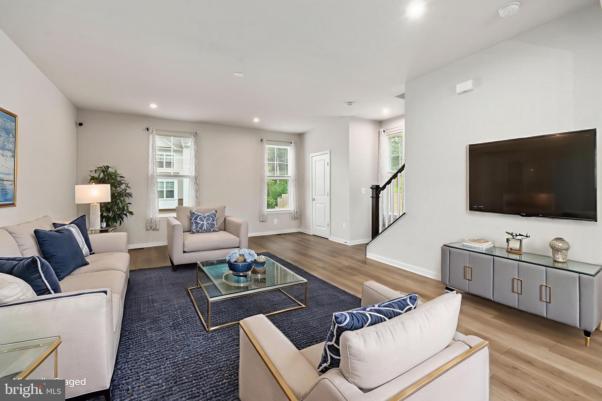 (VA ASSUMABLE 5.25%) This well-maintained, three-level, end-unit townhome with a one-car garage is the perfect blend of comfort, style, and convenience—backing to peaceful trees for added privacy. Step into the welcoming front foyer, where you’ll find garage access and a versatile lower-level space foyer with cozy carpeting, luxury vinyl plank flooring, and rough-ins for a future bathroom—ready for your personal touch.
Upstairs, the heart of the home unfolds in an open-concept design filled with natural light from windows on three sides. The gourmet kitchen features a large island with sink, gas range with exhaust, garbage disposal, and an abundance of recessed lighting. A spacious walk-in pantry and an off-kitchen office nook add both style and functionality. The dining area flows into an enormous living room, making it perfect for gatherings. A rear covered porch offers a relaxing spot to enjoy your backyard views. Hardwood stairs, fresh landscaping out front, blinds and curtains throughout, and a convenient half bath complete this level.
Retreat to the serene owner’s suite, boasting two oversized walk-in closets, a ceiling fan, and a spa-like bath with dual vanities, a walk-in shower, and private commode. Two additional bedrooms, a full hall bath, and laundry room are also located on this level. All bedrooms are carpeted for comfort.
This one-owner home includes solar panels for energy savings, an alarm system for peace of mind, and low HOA fees. Ideally situated just minutes from Quantico Marine Base and about 35 minutes to Fort Belvoir, this property is move-in ready and waiting for its next chapter. Don’t miss your chance to own this beautiful, light-filled, and thoughtfully designed home, schedule your tour today! Dual Representation Allowed.
