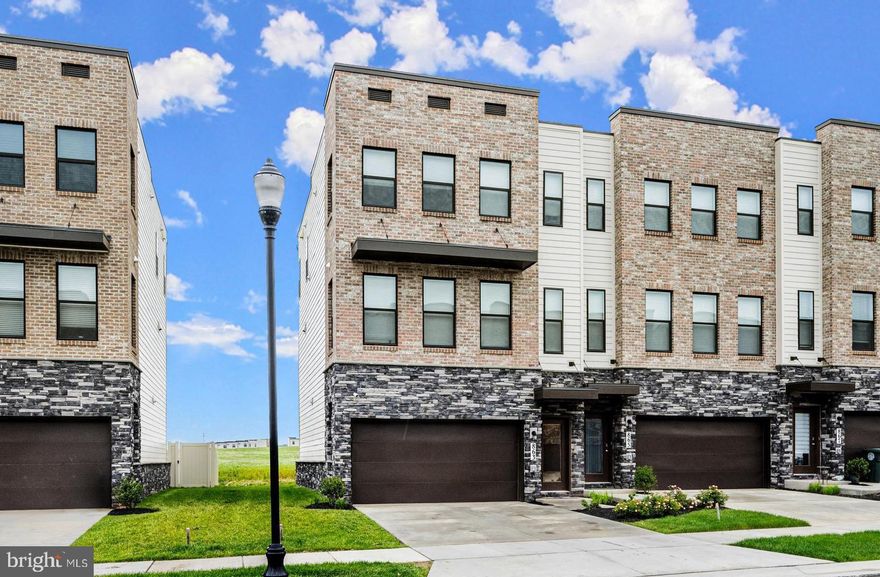 Move in Ready!  Introducing the exclusive Auburn floor plan, the largest townhome of the Renn Quarter community. This stunning 4-bedroom, 3.5-bathroom home with over 2,400 SQFT,  is a mere one year old and boasts a range of desirable features, including 9-foot ceilings, stainless steel appliances, luxurious wall-to-wall plank floors, elegant hardwood stairs, a convenient washer/dryer, a spacious master bathroom, and ample walk-in closets. The interior is adorned with luxury vinyl plank flooring, and a private composite deck off the kitchen provides a serene outdoor retreat. Additionally, the home has been enhanced with updated custom faucets, lighting, and hardware. Renn Quarter stands as the premier Lifestyle community, nestled in the highly coveted Historic Downtown Frederick. With its close proximity to shopping, parks, and dog parks, this residence offers the ideal blend of convenience and leisure. Moreover, its prime location allows for easy walking or biking access to the charming attractions of Downtown Frederick.