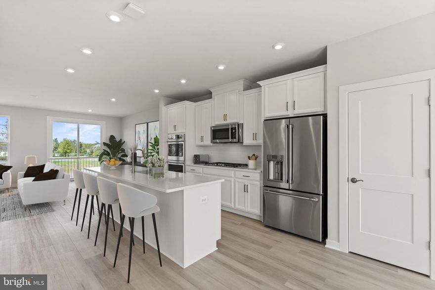 Brand new Stanley Martin 3-level garage townhome at Arcola Town Center in Sterling, VA! This 3-bedroom end unit townhome features an open-concept floorplan, a spacious kitchen with a large sit-down island, and plenty of room for the home chef and food enthusiast alike. A large and spacious family room and dining area make this space feel complete. At the end of the day, retreat to your primary suite with a private en suite bath and spacious walk-in closet. This room may become your favorite and will certainly inspire you to put your feet up and relax. Down the hall, two additional bedrooms with a full bathroom offer comfortable options for family and friends. Downstairs, the lower level recreation room and full bath is a comfortable spot for guests or you can transform to a private home office. Photos shown are from a similar home. Contact us to schedule a tour or stop by and visit our model home today! 

Outside your doorstep, you'll find a tot lot and neighborhood pool with a clubhouse. Directly adjacent to the neighborhood is the newly opened Elaine Thompson Elementary School. Everyday conveniences are just around the corner at Dulles Landing with Walmart, Dicks Sporting Goods, Bed, Bath & Beyond, Homegoods, and more. Additionally, there are many recreation options nearby with the new Hal and Bernie Hansen Regional Park and Dulles South Recreation Center just a short drive away. Whether you're looking to upsize, downsize, or purchase your first home, you will find a home that fits your lifestyle at Arcola Town Center. Visit us today!