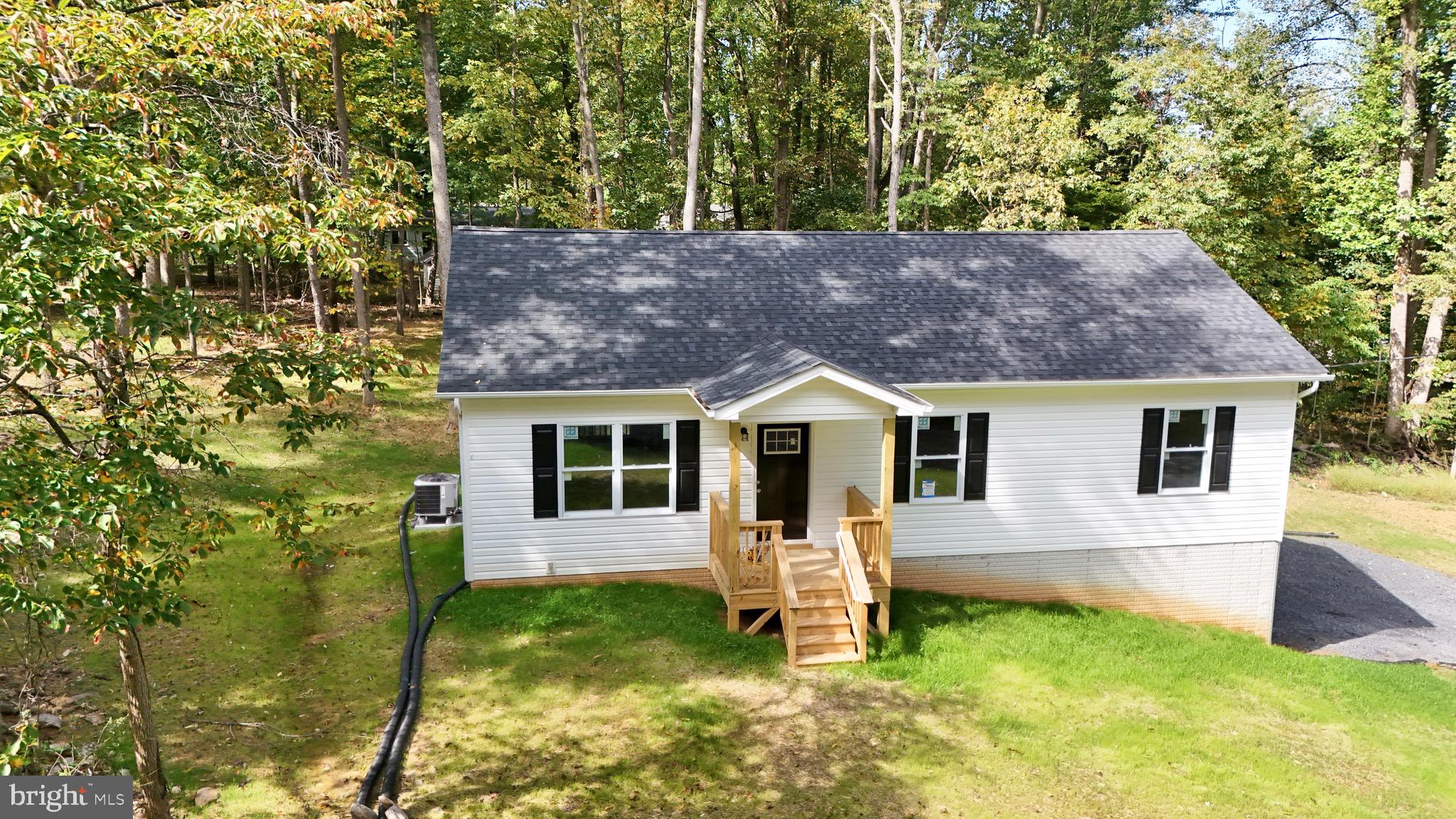 Brand New Rancher home Just completed on partially finished basement about a mile from the lake and club! Open floor plan with lvp flooring in the family rm, kitchen, dining and hallway area. The kitchen offers granite countertops, stainless steel appliances, and beautiful white cabinets. The primary bedroom offers on suite with walk-in shower and double vanity sink. Partial finished walk-out basement rough plumbed for full bath and one car garage. No HOA and large lot 0.73 Acres. This home has it all and won't last!