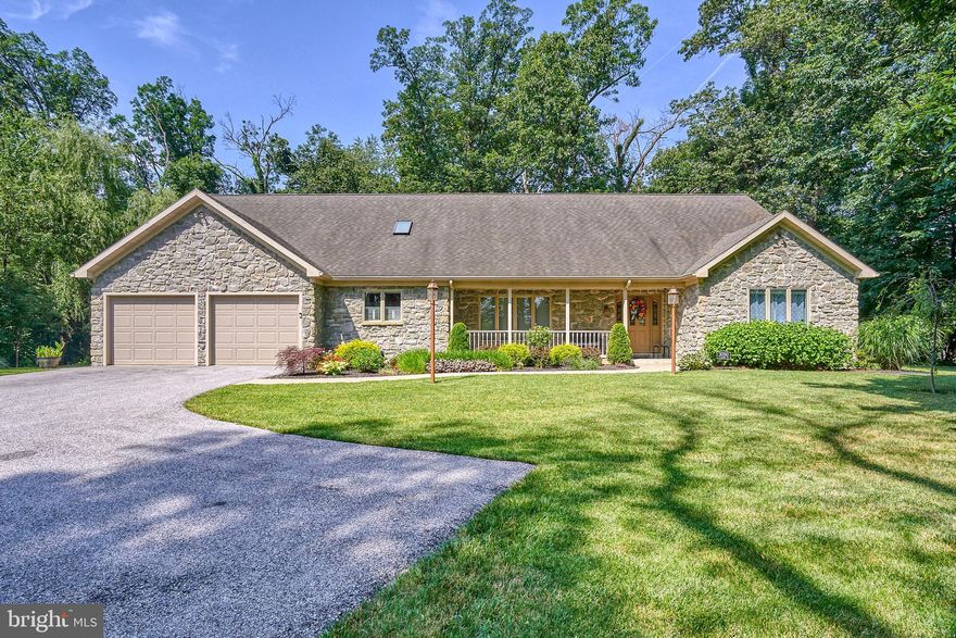Located at the end of  a private lane, this 2672 Sqft custom built rancher on a 1 acre wooded lot is sure to please.  This property is conveniently located in close proximity to I-83, Rt-30, York, Lancaster, Harrisburg and MD. Entering this home from the covered front porch, you are greeted by a large foyer with ceramic tile flooring and a coat closet.  The open floor plan offers a Living Room, Dining Room, and Large Eat-In-Kitchen that is all open into one Great Room with cathedral ceilings, skylights and ceiling fans.  The Living Room features a stone gas log fireplace and access to the screened in porch.  The spacious chef's  kitchen features a large island, Corian countertops, and all new SS appliances. There is a 1st floor laundry room with laundry tub and plenty of storage space.  The spacious primary suite  features a walk in closet and large bathroom featuring ceramic tile floor, jacuzzi tub and linen closet.  The second bedroom also features a walk in closet and it's own private bathroom.   The third bedroom features 2 closets, built ins, and 9 light french doors.  There is a 1/2 bath with hardwood flooring and wainscoting. Off of the Living Room there is a 9 X 19 screened in porch with recessed lights and a ceiling fan.  Off of this porch is a stamped concrete patio.  If you enjoy nature, this is the backyard you have been waiting for.  The owner regularly sees Deer, Turkey, Fox, etc. in the backyard.  The attached garage is 21' wide by 22' deep. with insulated doors.  The Basement offers additional storage space, an outside entrance, and is home to the central vacuum system, 50 gallon hot water heater, water softener system, Lenox high efficiency furnace, and radon system.  This is an amazing property in an amazing setting, in an amazing location.