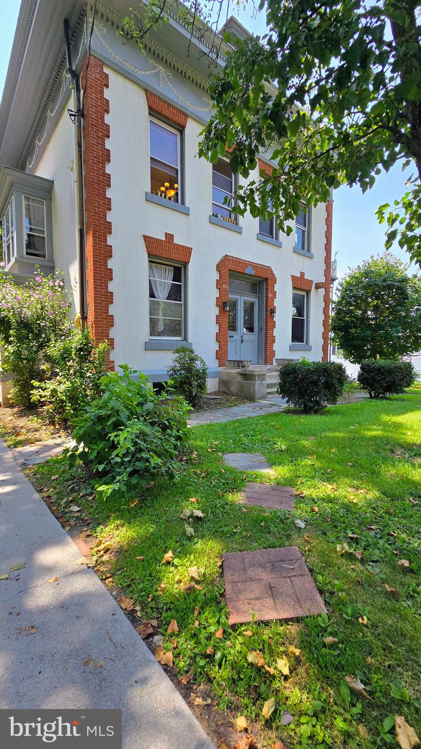 Step into timeless elegance in this beautifully maintained Victorian building. Enter through a charming tiled foyer and ascend the curved wood staircase with carved details to your 3rd-floor apartment. This 2-bedroom, 1-bath unit features a living room with a skylight, an eat-in kitchen, and the convenience of an in-unit washer and dryer. Off-street parking is included, and the historic character of the home makes every day feel special. A rare opportunity to live in a piece of local history while enjoying modern comforts!