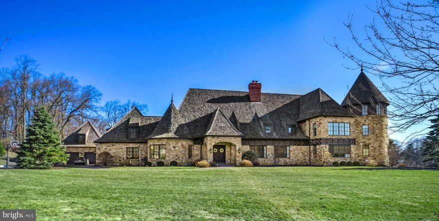 The inspiration of a passionate and innovative home builder shines through in the detailed design and exceptional floor plan of this Myron Haydt original. European influences are evident in the stunning fieldstone and brick exterior, dramatic cedar shake rooflines, and captivating turrets.        Luxurious amenities and outstanding finishes include thick oak and marble floors, extra high baseboards, deep crown moldings and curved walls. Upgraded light fixtures and custom window treatments highlight elegant living areas that include 2 fireplaces, a large dining room, and flexible spaces for work and play. The stunning kitchen combines beauty and functionality with a custom wood coffered ceiling, solid marble countertops, stainless appliances, and plentiful prep, pantry and entertaining space. Spacious primary bedroom suites are found on the main and second levels. Both are outfitted with dual walk-in closets, sizable sitting/exercise areas, and sumptuous baths appointed with jetted tubs, walk-in showers, and custom vanities. Three additional en suite bedrooms and two powder rooms offer the superior accents one would expect from a home of this caliber. The newly updated lower level includes two finished rooms connected by a full bath, while the large storage area features a walk-out to the expansive backyard bordered with pine and pear trees. The attached 3-car garage is  complemented by a heated 2-car detached garage with loft storage. Two intricate brick patios are accessed from the sunroom and family room for intimate dinners under the stars or lively celebrations.       The distinguished neighborhood enjoys a premiere location close to the Lehigh Valley Hospital, Interstate 78, and Stabler Corporate Center. Shopping, dining, and entertainment venues are just minutes away at the Saucon Valley Promenade.