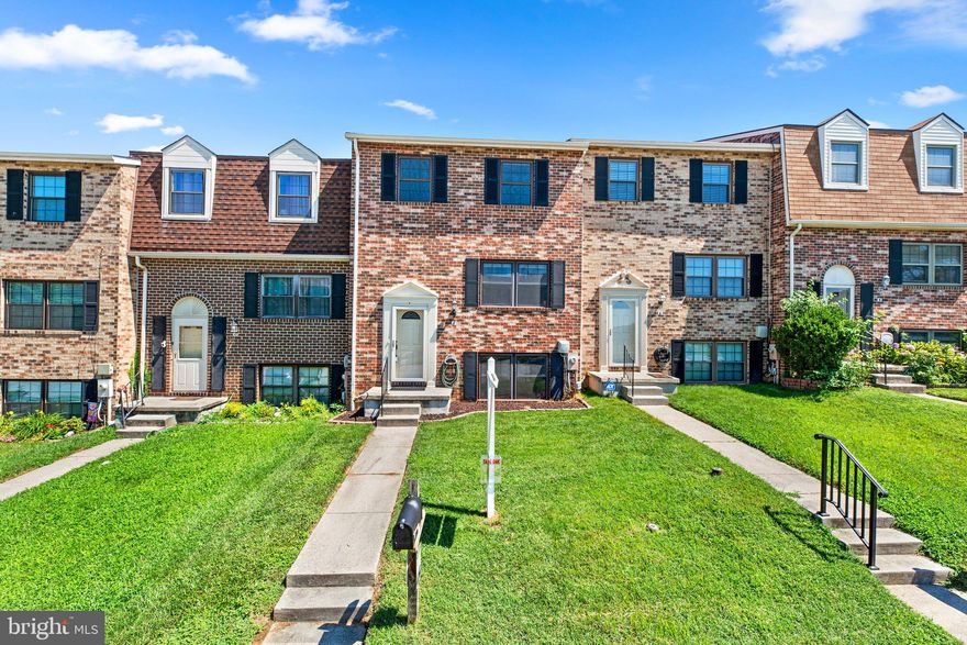 Brick front split foyer townhome located in Broadfield at Wilton Farms offers 3 finished levels, neutral paint throughout, deluxe hardwood flooring, a spacious living room filled with natural light, an open dining room with special lighting and a slider walkout to a deck  and backyard.  With traditional styling, the kitchen offers white raised frame cabinetry, sleek counters, tile backsplash with inlays, gleaming hardwoods, crisp white appliances, and a peninsula island with an elevated breakfast bar.   Upstairs are the bedrooms including an owner's suite hosting a walk-in closet and full bath.  Experience fun and relaxation in the lower level showcasing a family room with twin ceiling fans, a half bath, a laundry and utility room. and dedicated storage.  Easy access to public transportation, shopping, restaurants, commuter routes, recreation, the airport, UMBC, a MARC train station, downtown Baltimore, and Rolling Road Golf Course.