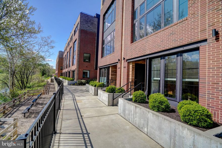 Welcome to the serene riverside haven known as "The Locks", a townhome community nestled amidst the historic allure of Manayunk. Here, between the meandering Schuylkill River and the storied Manayunk Canal, indulge in captivating views that grace every corner of this elegant abode.

A leisurely stroll over the canal leads you to the vibrant pulse of Manayunk, where a tapestry of culinary delights, artistic havens, and eclectic boutiques await your exploration. Immerse yourself in the distinct downtown charm, while nearby nature trails, bike trails, and riverbank paths beckon for tranquil escapes and leisurely jaunts.

Venture beyond the neighborhood with ease, courtesy of seamless access to Center City Philadelphia, The Main Line, and King of Prussia via various transportation options, from regional rail to Interstate 76. This expansive townhome exudes luxury, boasting classic brick facades, ample outdoor spaces, and an array of modern amenities, including two zone heating and cooling a coveted 2-CAR GARAGE AND A 5-STOP ELEVATOR, taking you all the way to top floor for easy access to your private roof deck with magnificent views. 

Step inside to discover a sanctuary of comfort and refinement with EnergyStar efficiency and unparalleled convenience. Revel in the luminous interiors, adorned with hardwood floors, soaring ceilings, and panoramic windows framing enchanting river vistas.

Custom touches abound with electric roller shades and solar window tinting, ensuring both comfort and privacy. The gourmet kitchen stands as a testament to culinary excellence, outfitted with stainless steel appliances, bespoke cabinetry, and an inviting island for culinary creations and warm social gatherings.

Ascend to find respite in well-appointed bedrooms, luxurious baths, and clever storage solutions throughout, including an oversized laundry room on an upper level. The private owner's suite offers a tranquil retreat, complete with a terrace for alfresco moments a, CA style closet and a spa-like en-suite bath for indulgent relaxation.