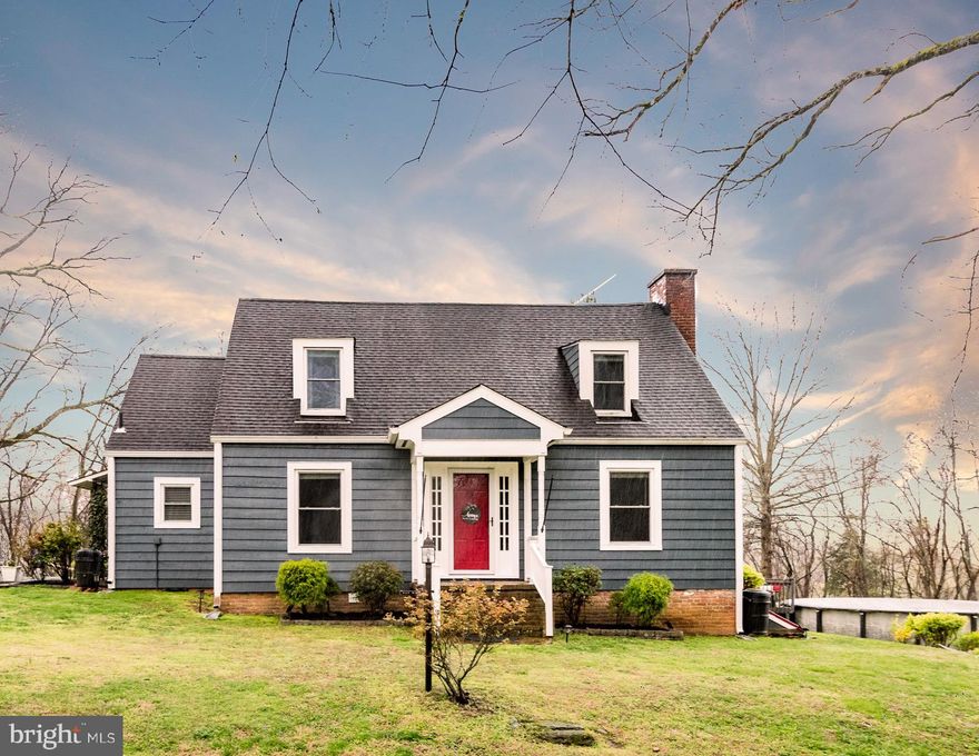 Welcome to your piece of rural paradise, atop the beautiful cliffs bordering the James River.  Pull up the stone drive to see a dreamy blue cape cod overlooking a wooded hillside.  Offering first floor living, this home has a flowing floorpan with four bedrooms and two full bathrooms.  Walk in the solid wood front door, or in the side entrance into the updated kitchen where you will find beautiful tile floors, granite countertops, and stainless steel appliances.  The bathrooms are upgraded as well, alongside original hardwood floors, newer light fixtures, and brick fireplaces making this house the perfect symphony of upgrades and charm.  Lounge on the porch enjoying the serenity of life so near to the James, or take a quick trek over to the public landing to see the water up close.