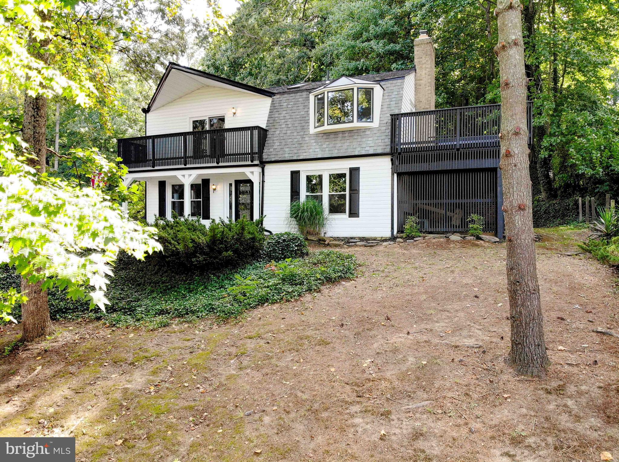 Don't miss this incredible waterview home located in the sought-after waterfront community of Glebe Heights. Situated on over 0.60 acres across 7 lots, this property offers rare space and privacy, plus a large detached garage with an additional workshop—perfect for hobbies, a home business, or a dream man cave.
This charming home has undergone extensive renovations and is move-in ready for its next owner. Step into the spacious family room featuring a cozy fireplace, which flows seamlessly into the updated kitchen with dining area—a perfect space for everyday living. For more formal entertaining, enjoy the separate dining room that opens to a bright and inviting living room. Off the kitchen, a versatile enclosed porch adds additional living space and overlooks the private yard with an attached deck. A main-level full bath adds convenience. Upstairs, the primary bedroom offers peaceful water views, while three additional bedrooms provide flexibility—two even open to upper-level decks with panoramic views of Glebe Bay. The fully remodeled upstairs bathroom features a double vanity, tub/shower combo, and stylish new flooring. The property sits elevated, offering sweeping water views, and the detached garage with a rear workshop offers endless possibilities. There may be potential to subdivide and build, subject to county approval—adding even more value to this special property. Living in Glebe Heights means enjoying a true waterfront lifestyle, with access to the community beach, dock, and year-round social events. All this, just minutes from Downtown Annapolis, major highways, shopping, and an easy commute to DC, VA, and Baltimore. A rare opportunity for waterview living with space to grow—schedule your private tour today!
