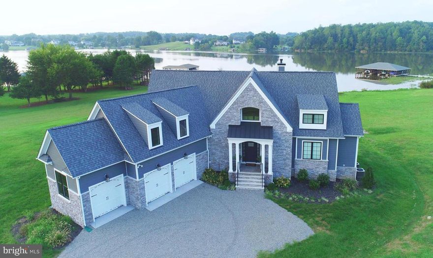 OPENS CANCELLED - HOME RECEIVED MULTIPLE OFFERS AND IS NOW UNDER CONTRACT.  MOVE FAST ON THIS RARE OPPORTUNITY TO OWN  A MODEL PERFECT, LITERALLY MOVE-IN READY WATERFRONT HOME ON BEAUTIFUL LAKE ANNA!   Vacation at home everyday with  exceptional water views year round.  This fully furnished home offers casual elegance from every room.  Relax as it's all been done for you!  Just freshly painted, this home comes fully stocked with all furniture, kitchenware, artwork, linens, bedding, kayaks, and more!  A FABULOUS rental opportunity with a proven record of return on investment!  Or, just enjoy this vacation home for yourself and your family!  Plenty of room to unwind and relax, with 5 oversized bedrooms, 3 full baths and 1 half bath, on 3 fully finished, gorgeous levels offering almost 4,000 square feet of space!  Main level primary bedroom suite opens to expansive deck overlooking the water,...wake up to beautiful sunrises as you awaken each day.  Primary suite also offers enormous walk-in closet, and spa bath with separate jetted tub and frameless shower.  This home is bathed in light from floor to ceiling with 2 story main room featuring stunning stone fireplace with overlook.  Beautifully sited on a level, professionally hardscaped and landscaped lot backing to Lake Anna, with over 200 feet of waterfront!  Enjoy sunrises and picturesque sunsets atop the private dock, featuring a large upper level, fun tiki room, and 2 slips for a boat and/or jetskis!  And - best of both worlds - this private oasis is a quick walk across the street to Lake Anna's Boardwalk - featuring home made ice cream, arcade, 18-hole mini-golf course, Tim's Restaurant, and more!  After a fun day of jetskiing or swimming (or just soaking up the sun), head over for dinner and drinks, or let the kids hit the arcade and enjoy ice cream!   New photos to be uploaded by 4/26, which will show most recent improvements of custom oversized deck (now quadrupled in space from pictures), with an expansive lower level  custom stone patio, firepit,  hot tub, and private 2-level dock.  Lovely side screened porch off of kitchen, too!  Spacious 3-car garage and a picturesque 1.3 acre lot.    Every day is a vacation at this lovely home!