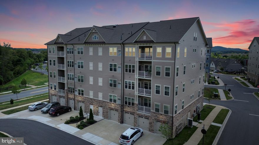 Here's your opportunity to own one of the highly sought-after penthouse condos in the Woodlands of Urbana, Maryland's premiere 55 plus community! These penthouse condos rarely come on the market-- so don't miss your opportunity!   With grand 19-foot high volume ceilings, an open concept floorplan and upstairs loft,  this beautifully upgraded home offers over 1,700 square feet of refined living space. The smart floorplan features two large bedrooms and two ensuite bathrooms--each tucked away in their own corner of the home for optimal privacy. The gourmet kitchen features upgraded 42" cabinets, a custom tile backsplash, stainless steel appliances, quartz countertops, and a large island with a breakfast bar. The kitchen is seamlessly connected to the living and dining areas, creating the ideal space for both entertaining guests and everyday living. From the light-filled living area, step outside to the private covered balcony–your outdoor retreat. The standout feature of this condo is the added loft—perfect for use as an additional entertaining area, TV watching or reading area or even a play zone! The Primary Bedroom Suite is a luxurious escape with two large closets and an ensuite bathroom with a dual quartz vanity, a large tiled shower with a convenient built-in bench, and a linen closet for extra storage. The equally spacious secondary bedroom features a large closet and an ensuite bathroom with an upgraded quartz vanity and a custom tile tub/shower combo. All this, plus a laundry room, a convenient coat closet in the entry and an expansive walk-in storage closet. The oversized one-car garage provides space for your vehicle and additional storage needs. Access the elevator from your garage via a short hallway.  The amenities for residents of the Woodlands are truly exceptional, and include a heated pool, fantastic clubhouse with  billiards, a poker room, kitchen, extensive gym, yoga/exercise studio, golf simulator, and meeting rooms for the myriad of community and group activities. Plus, you can enjoy walking trails, pickleball, bocce courts, an herb garden, covered pavilions, putting green and two dog parks! This condo is conveniently located near all of the great features of Urbana including a grocery store, restaurants, library, senior center, doctor’s offices, YMCA and multiple parks--making it easy to enjoy everything the area has to offer.  Schedule your showing today!