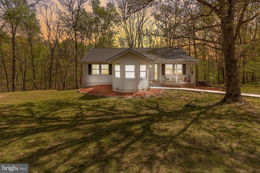 Welcome to a beautifully updated ranch-style home set on 4.66 wooded acres, offering privacy, space, and a peaceful natural setting. With over 2,600 square feet of living space, this 5-bedroom, 3-bath residence provides room to spread out while enjoying the calm surroundings of a quiet road with only a few nearby homes.

Inside, the home has been extensively updated in 2022, giving it a fresh, modern feel throughout. Improvements include a new roof, updated flooring, lighting fixtures, fresh interior paint, and a finished basement. The kitchen has been thoughtfully renovated with new cabinetry, granite countertops, and updated appliances, creating a bright and functional space for cooking and gathering. A new HVAC system adds efficiency and comfort year-round. The main level also features a convenient laundry area for everyday ease.

The finished lower level expands the living possibilities with additional space that could serve a variety of needs. With its own full bathroom and a second laundry area already in place, it offers flexibility for extended household arrangements, recreation space, a home office, or guest accommodations.

Outdoor living is just as appealing. Step out onto the rear deck and enjoy the quiet setting surrounded by mature trees and natural scenery. The nearly five-acre property provides space to explore, garden, or simply enjoy the outdoors while still being conveniently located near major highways for commuting and travel.

Located near the City of Martinsburg, this property offers access to a growing and vibrant community in the Eastern Panhandle of West Virginia. Martinsburg is known as the Gateway to the Shenandoah Valley and serves as the county seat of Berkeley County, one of the fastest-growing areas in the state. Residents enjoy a blend of historic charm, expanding amenities, and proximity to outdoor recreation, shopping, dining, and regional travel routes.

This property combines the comfort of modern updates with the tranquility of a wooded setting, creating a unique opportunity to enjoy both privacy and convenience. Schedule your visit and experience everything this home and its surroundings have to offer.