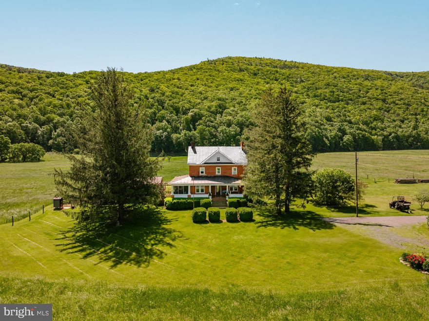 Step back in time—without giving up a single modern luxury. With over half a mile of private frontage along the South Branch of the Potomac River, this extraordinary 85+ acre property offers a rare opportunity to live immersed in natural beauty, rich history, and timeless serenity. From fishing and kayaking to skipping rocks or simply soaking in the peaceful sound of flowing water, the river becomes a way of life. A private gravel drive welcomes you home, crossing a charming bridge with the river flowing gently beneath. At its heart sits a restored 1812 farmhouse with over 2,500 square feet of beautifully updated living space, featuring oak and heartwood floors that blend historic craftsmanship with modern comfort. The land includes approximately 30± acres of fertile tillable fields, 26± acres of pasture currently leased for $1,500/year, and 30± acres of mature woods for hiking, hunting, or riding. A large stocked pond offers a perfect spot for fishing and reflection, while fruit trees and berry bushes provide seasonal harvests and homemade treats. Panoramic mountain views surround you with year-round beauty, and a hand-hewn log cabin tucked beside a babbling creek serves as an ideal guest cottage, studio, or peaceful retreat. This is more than just a home—it’s a legacy, a lifestyle, and the kind of place you dream about and now, it can be yours.