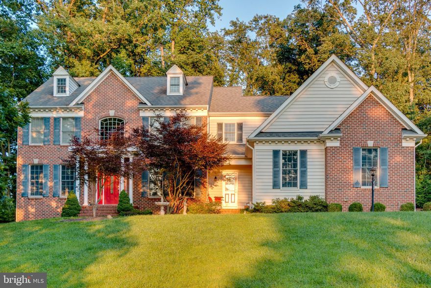 Don't miss your opportunity to own this stunning custom built 4 bedroom 3.5 bath brick front colonial situated on a private 1.47 acre lot surrounded by woods! Nested at the rear of the lot, this property sits above the open spaces of the front yard creating a striking curb appeal that's no easy task to find! A walkway from the turned 3-car garage leads you to the eye-catching front entrance, under the captain's walk, and into the expansive two-story foyer. As you make your way through the main floor, you'll immediately notice the custom double bullnose staircase and gleaming custom hardwoods that flow throughout the entire home. The inviting open floor plan with 10' ceilings brings you to the custom professional gourmet kitchen which includes a large granite island, custom 42" cherry cabinetry w/ under cabinet lighting, walk-in pantry, and more conveniences than you could ever imagine! Cooks will love the professional grade stainless appliances featuring a brand-new Kitchen-Aid 48" built-in refrigerator, dual ovens w/ convection, 36" 6-burner gas range with VentaHood, under-counter built-in Viking wine refrigerator with professional handles, quiet-run dishwasher, and a large dual stainless steel Kohler sink and faucets. This space also offers views of your wooded backyard with Anderson French doors to access the private paver patio. Warm the heart in the spacious family room featuring cathedral ceilings, large ceiling fan, custom wood plantation shutters, brick gas Heat-n-Glo fireplace, and a massive custom mantel to tie it all together. Other main level rooms include a private study, formal living and dining rooms, a well-appointed powder room with Kohler Memoirs fixtures, and a mud room which includes it's own exterior front entrance. This level also includes lots of custom moldings throughout including chair-rail, crown, & gorgeous wainscoting. Upstairs, the sprawling master suite features vaulted ceilings, large ceiling fan, Heat-n-Glo gas fireplace, separate sitting room, custom walk-in closet, & a luxurious private bath. The gorgeous spa like en-suite bath boasts an over-sized jetted 2+ person soaking tub, dual granite vanity with Kohler sinks & faucets, built-in under-counter refrigerator, custom hardwood & glass cabinetry, walk-in 3-headed Kohler shower with massage heads, and Italian tile throughout. The second floor also features 3 additional bedrooms (one with a private bath), a laundry room, and a shared full bath in the hall. The full walk-out basement takes care of all your storage needs and also has potential for even more finished living area! This space is already fully insulated, water proofed, and includes a rough-in for a full bath. This is the perfect property for those who appreciate space (both inside and out) as well as all the modern conveniences such as the dedicated audiophile circuitry in the study and family room. No HOA here! This exceptional home is conveniently located minutes from all major roadways, shopping, restaurants and more. Schedule your showing today!