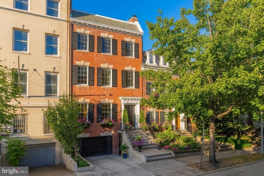 Price improvement! Welcome to 2137 R Street NW, a stately Federal residence perfectly positioned on one of the most sought-after blocks in Washington D.C., where Dupont Circle meets Kalorama and Georgetown, near the historic Spanish Steps and the distinguished Embassy Row. Nestled on the premier stretch of R Street, this home embodies timeless elegance and modern refinement. A gracious and flowing floor plan unfolds upon entry, revealing exquisite architectural detailing, intricate millwork, and fireplaces that define the home’s enduring character. The main level offers an impressive sense of scale with a grand living and dining room, a butler’s pantry with built-in wine storage, and a showpiece designer kitchen, meticulously crafted for both intimate dinners and large-scale entertaining. French doors extend the living space outdoors to a tranquil private patio, offering an idyllic setting for alfresco dining or quiet moments surrounded by lush greenery.

The second level is devoted to a primary suite, accompanied by an inviting flex space and a beautifully appointed wet bar. A spacious multi-season screened porch, complete with integrated heat lamps, provides a serene retreat that captures the peaceful ambiance of Kalorama. The upper floors continue to impress with generously sized guest bedrooms and a dedicated home office, offering flexibility. The fully finished lower level includes a complete au pair or in-law suite, thoughtfully designed with a second kitchen, ideal for guests or extended stays. A rare attached secure garage adds exceptional convenience. Classic yet contemporary, 2137 R Street NW stands as a testament to architectural grace, thoughtful design, and modern luxury, a residence in one of Washington’s most prestigious and historically significant enclaves.