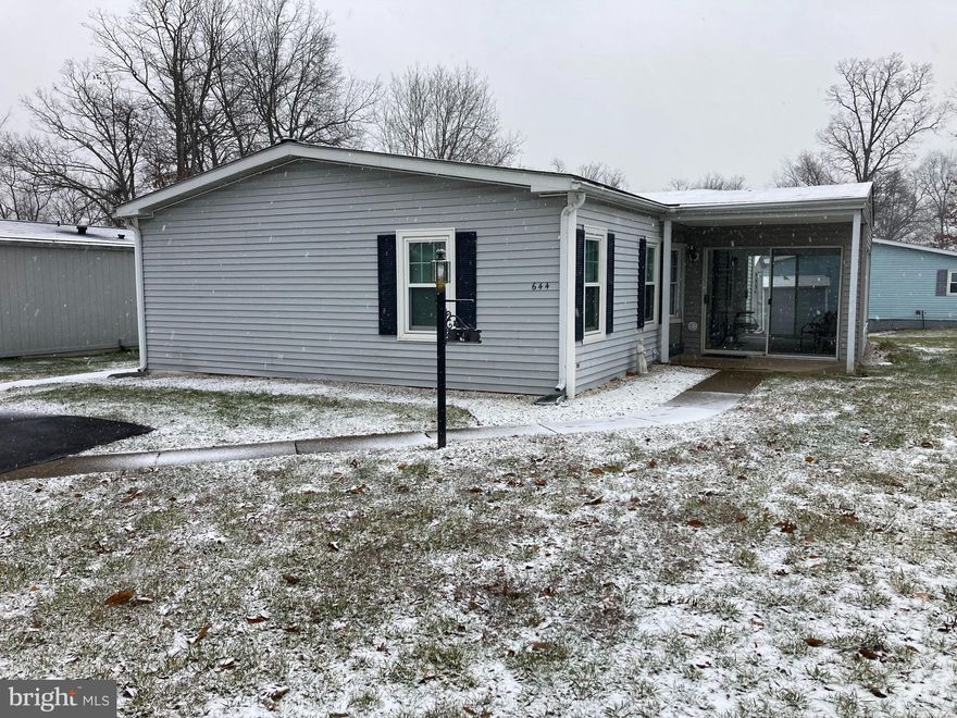 If you are looking for a spacious 2 bedroom/2 bath with an enclosed porch, side deck, and a great location, here is what you have been waiting for! This home comes with 2 car private parking space with a short walkway to your enclosed porch that has sliding doors in two locations and is surrounded by windows.   Priced for some updating and personal touches, this home provides a huge living room with a coat closet and roomy dining room space.   The kitchen has lots of cabinets and counter space and comes with a breakfast bar.  The refrigerator and microwave are newer and remain with the home including the other appliances.  Bedrooms and baths are on opposite sides of the home for privacy when entertaining guests.   Just off the dining room is the utility room with a washer and dryer, utility closet/pantry, and an exit door to a side deck.  Make your appointment soon and update to your satisfaction!