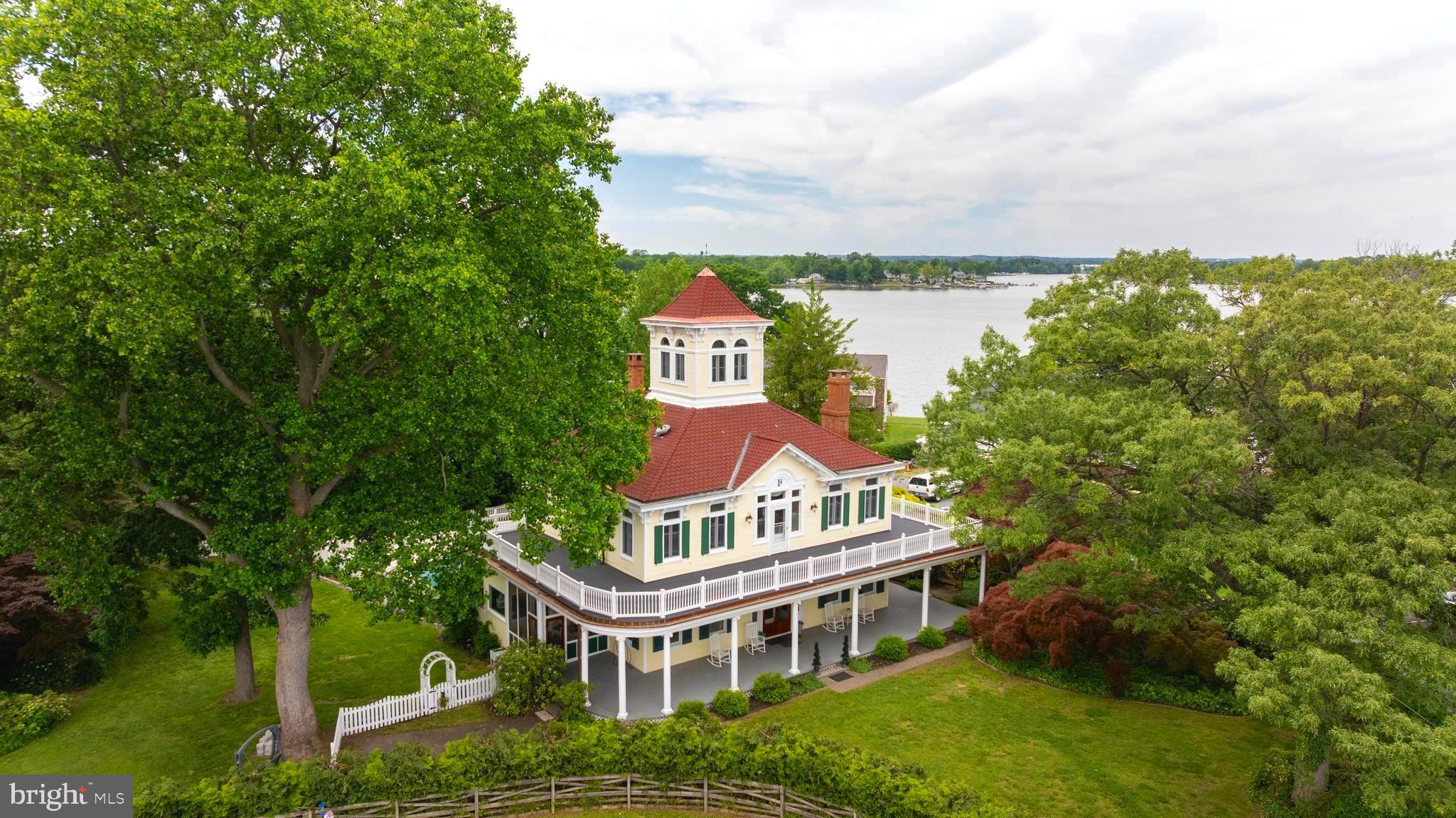 Maryland Historical Homes, of Monument Sotheby's International Realty, is delighted to present a very special Italianate home steeped in Maryland history. Bauernschmidt Manor sits on land once owned by Enoch Pratt, who named it "Planter's Paradise" due to the rich urban sassafras soil. The grass is bright green, and the soil supports stunning professional landscaping. The home was built by Robert C. Ullrich for renowned brewer and philanthropist Frederick Bauernschmidt and his wife, Agnes, in 1909, as a summer home. Mr. Bauernschmidt founded the American Brewery, which is now the headquarters for the very beautiful Humanim building. He sold the company in 1923, and many empty bottles of beer from the American Brewery, and from his father's company, the George Bauernschmidt brewing company, exist to this day, and are on display in the home.
There are four incredible bedrooms and five full bathrooms, as well as sitting rooms, a ground level screened porch, a ground-level wraparound porch and a wrap-around veranda, a Juliet balcony overlooking the well-maintained saltwater pool, and a cupola with water views that are simply breathtaking. Enjoy the stunning landscaping while enjoying the breeze from the water.
A community beach and boat access are available for use.
This home combines the very best of wonderful historic detail while still being suited for modern living, and is looking for its next steward as it moves forward into its next chapter in history.
Fun fact: the land was a popular duck hunting spot, and Presidents Harrison and Cleveland both hunted here. As a Baltimore County Historical Landmark, there are tax incentives available for owners of such properties. The home was used as a Bed and Breakfast at one time, as all bedrooms are ensuite, and that usage is still an option given all Maryland Bed and Breakfast permits and licenses are approved. The original "Bauernschmidt Bed and Breakfast" sign hangs in the home.
Many upgrades have been completed over the years, as well as many in 2025; please see documents for a complete list; it is extensive and comprehensive. A list of furniture that conveys is available in the agent documents. Plans for a carriage house have already been drawn up for use.
Don't miss this wonderful value with incredible Maryland history.