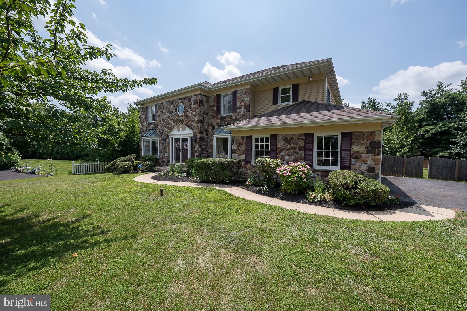 Welcome to 927 Capitol Circle, an exceptional residence nestled on a quiet cul-de-sac in one of East Norriton’s most walkable and family-friendly neighborhoods—just steps from the community elementary school. With over 3,170 sq feet of living space, this beautifully updated 4 Bedroom, 2 full Bath, 1 half Bath home seamlessly combines classic charm with modern luxury across every detail. Step inside to find a gracious 2-story Foyer accented with Brazilian hardwood flooring, which continues into the formal Living Room and Dining Room—installed in 2018 for lasting elegance and warmth. The fully renovated Kitchen, completed in 2021, is a chef’s dream featuring custom cabinetry, striking Sacuri granite countertops, an oversized stainless steel farmhouse sink, a chic glass tile backsplash, luxury vinyl plank flooring and new stainless appliances. Adjacent to the Kitchen, the spacious Family Room has been updated with new carpeting, a tiled fireplace, and a renovated wet bar topped with coordinating Sacuri granite—perfect for relaxing evenings or entertaining guests. The upper level is anchored by a luxurious Primary Suite, offering a tranquil Sitting Room with newly added custom built-ins (2025) and a fully remodeled en-suite luxury Bath. Renovated in 2023, the primary Bathroom feels like a private spa retreat, complete with a freestanding soaking tub, an expansive glass walk-in shower, dual vanities, and stylish new flooring. All bedroom closets, including the spacious walk-in closet in the Primary Suite, have been upgraded with custom closet systems (2024) to enhance functionality and organization. The hall Bathroom was updated in 2023 with a new bathtub and modern surround, continuing the home’s cohesive, upscale aesthetic. A bright, enclosed three-season room extends off the Family Room, surrounded by sliding glass doors and screens to enjoy outdoor views year-round. The oversized Laundry/Mud Room includes a custom-built hall tree bench, offering a practical and inviting everyday entry space from the 2-car garage. Throughout the home, elegant crystal lighting fixtures add a refined touch to the Foyer, Kitchen, Breakfast Area, Primary Bath, and Sitting Room. Additional improvements include a full roof replacement (2020) and a new HVAC system (2021), offering peace of mind and energy efficiency. This impeccably maintained home offers timeless design, thoughtful upgrades, and an unbeatable location. Schedule your private showing today to experience all that 927 Capitol Circle has to offer.