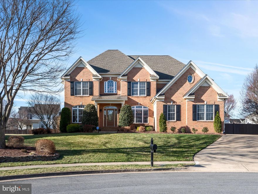 Exceptional craftsmanship defines this custom-built 5-bedroom, 4.5 bath Colonial, perfectly situated in a tranquil cul-de-sac. Designed for both comfort and convenience, this home features an oversized 3-car garage and a thoughtfully designed customized floor plan.

As you step through the front door, the main level greets you with a bright and inviting layout, highlighted by a stunning two-story foyer with a graceful chandelier. This level features a bedroom with a full bath, formal living and dining rooms, and a sunken family room warmed by a gas fireplace with an elegant mantel. The gourmet kitchen is a chef’s delight, showcasing a spacious island, quartz countertops, custom cabinetry, stainless steel appliances, a built-in desk/office area, and a walk-in pantry. A charming breakfast nook opens to a covered back porch and deck, perfect for outdoor relaxation and entertaining.
Upstairs, the grand primary suite impresses with double doors, a tray ceiling, a generous sitting area, and a spa-like bath featuring a jetted tub, a separate shower, custom cabinetry, and an extraordinary walk-in closet, complete with a custom organizer with soft-close drawers. The in-law/au pair suite offers built-ins a private bath with a corner jetted tub and separate shower, and a spacious walk-in closet with an organizer and a separate linen closet. A third en-suite bedroom provides a perfect private retreat for guests.

The lower level extends the living space with a fifth bedroom featuring a walk-in closet and private exterior access that leads to the driveway area.   There is also a large family room with a game area, a half bath, and a utility room that completes the basement living space.  The backyard is a peaceful oasis, backing to trees and common area, fully enclosed by a privacy fence for ultimate relaxation on the covered porch and deck.

The oversized 3-car attached garage is both functional and stylish, featuring a professionally painted floor, ample storage, and three newer garage door openers.

This home has been thoughtfully updated with a new roof installed in August 2019, a new upper-level A/C in 2022, a main-level furnace replaced around 2021, a hot water tank updated in approximately 2018,  several newer appliances and a quality Aprilaire 5000 air filter for upper and lower HVAC units. 

Ideally located just minutes from I-81, Route 66, Winchester Medical Center, and Downtown Winchester, this home offers the perfect blend of luxury, space, and convenience.