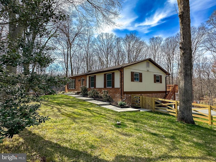 Immaculate home with more than 2700 finished sq. ft. nestled on a 1 acre corner lot in sought after Heritage Woods!  Just mins to Old Town Manassas, the VRE and the PWC parkway, this home features No HOA and features award winning schools. This home is the perfect retreat featuring beautiful, refinished main level hardwood floors and skylights.  Enjoy easy living with three generously sized main level bedrooms and two upgraded full baths with tile and granite. The front family room features a gas fireplace flanked by custom built-in bookcases. The kitchen has stainless steel appliances, including a double oven stove, tile, granite, and a large dining room w/ brick wall feature that opens to your heated screened porch with walk around deck that leads to a concrete sidewalk path. The walkout lower level offers plenty of extra space with its own updated full bath, private kitchenette, study and a 4th private bedroom - this space could be prefect for multi generational living and more!  You will enjoy the lower level recreation room with an energy efficient pellet stove . The backyard is enhanced with a charming brick wall fireplace that is a perfect spot for entertaining, and a gorgeous well manicured yard all surrounded by a trees.  The rear yard is fully fenced to include privacy gates to the driveway!  . There's an oversized garage, massive driveway and a shed that provides plenty of storage for your toys, tools and the like!  ***Improvements include: Roof and garage door (2018), HVAC, water filtration and front lawn sprinklers (2019), New SS kitchen appliances (2020), Driveway (2021), 2 4000W heaters for porch (2022), Refinished floors and all new paint (2022), New fence and gate (2023)