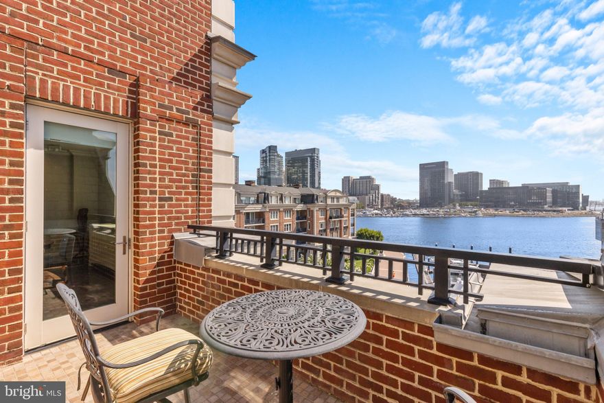 Waterfront Penthouse overlooking the harbor at The Ritz-Carlton Private Residences in Baltimore. This exquisite 2-bedroom, 2.5-bathroom, 2,133-square-foot penthouse is bathed in natural light and boasts stunning water views from every corner. The condo features high-end Viking stainless steel appliances, beautiful hardwood floors, and an open floor plan that seamlessly connects the kitchen with the dining area and a living room centered around an elegant vented gas fireplace. A private penthouse balcony extends from the living area, providing the perfect spot for morning coffee or an evening nightcap. The expansive primary suite includes a large walk-in closet and a spa-like bathroom with double vanities, a spacious walk-in shower, and a garden soaking tub. The sizable second bedroom, currently set up as an office with two built-in desk areas and perfectly accommodates a sleeper sofa, can easily be converted back into a traditional bedroom.  This room is connected to a generously sized bathroom with a walk-in shower. Every closet has been customized with a shelving system. Two deeded parking spaces and a separate storage area add to the convenience of this remarkable home. Enjoy the legendary 5-star amenities at The Ritz-Carlton Residences, including 24/7 concierge, valet, and security services, an indoor heated saltwater pool, a well-equipped gym with an additional movement room, a theater, a residents' lounge, a boardroom, a clubroom, six guest suites, multiple professional manicured garden areas, and more. Arrive directly into your private vestibule via a semi-private elevator and immediately experience the effortless Ritz-Carlton lifestyle. One Year Home Warranty provided by Seller.