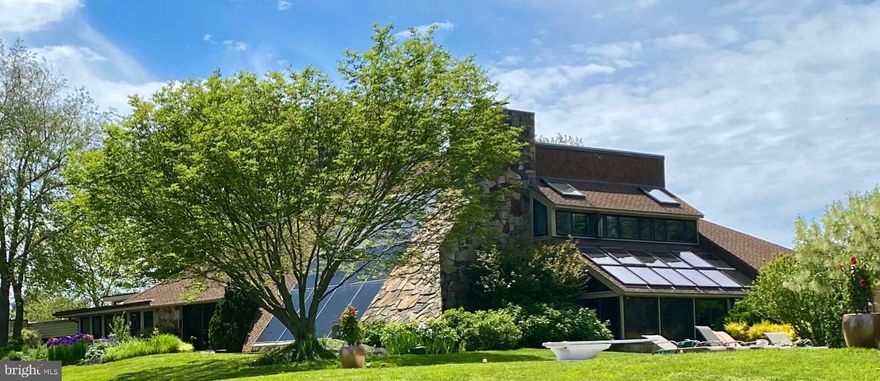 Welcome to 3207 Bennett Point, a breathtaking Norman Jaffe–designed waterfront estate set on over 5 private acres along the widest stretch of the Wye River. Designed to maximize its setting, the home offers floor-to-ceiling glass, seamless indoor-outdoor living, and panoramic water views from nearly every room.
The main residence showcases timeless craftsmanship with Tennessee Quarry FlagStone, rich hardwoods, and warm wood-clad ceilings and walls. Expansive living areas and a waterfront screened porch highlight the home’s indoor-outdoor flow, while a home office, elevator, and a gourmet kitchen that was renovated in 2017 with an oversized island, contemporary cabinetry, and premium finishes that add comfort and function. Upstairs, the primary suite offers a stunning wall of glass framing the river, a fireplace, dual walk-in closets, and a spa-inspired bath. The estate’s separate 4-bedroom, 4-bath guest house was taken down to the studs and completely reimagined in 2017. The renovation added two bedrooms and two bathrooms, a full kitchen, and a spacious living area all with sweeping water views. Providing luxurious accommodations for family and guests. Outdoors, the property delivers resort-style amenities at every turn: a 22’x44’ PebbleTec heated pool with pool house, a Bradford hot tub designed for year-round relaxation, and a 340’ pier with 8’ MLW, boat lift, davits, and deep-water access for boating, fishing, and swimming. Recent upgrades (2017) include kitchen and bath renovations, the guest house addition, elevator installation, whole-house generator for the main and guest house, new insulation, HVAC, electric service, lighting, and flooring- ensuring peace of mind for years to come. With expansive shoreline, mature landscaping, and sunset views over the Wye, this estate pairs architectural pedigree with resort-like amenities that is just minutes from the Chesapeake Bay Bridge. Experience the pinnacle of Eastern Shore living at 3207 Bennett Point.