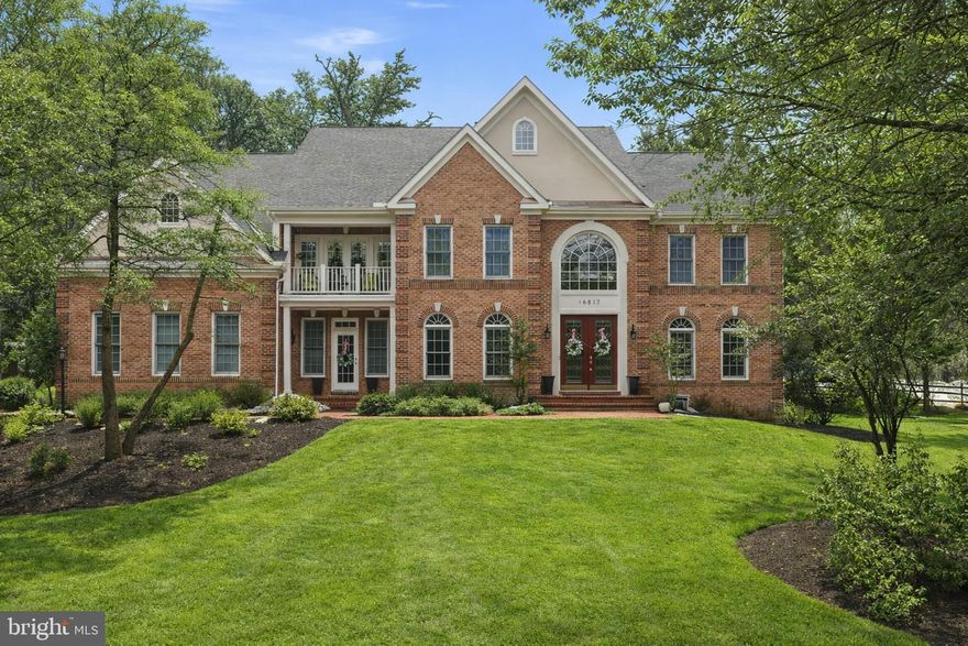 This stunning luxury estate offers over 8,000 square feet of sophisticated design, architectural grandeur, and elevated living. Set against a picturesque, wooded backdrop and enhanced by a brand-new roof, this award-winning Christopher Wren residence seamlessly blends timeless elegance with modern comfort.

From the moment you arrive, the stately brick façade, manicured landscaping, and side-entry 3-car garage create an impressive first impression. A charming walkway leads to grand double eight-foot leaded glass doors that open into a breathtaking two-story marble foyer, complete with an elegant chandelier and dramatic curved staircase. Gleaming hardwood floors, intricate crown and chair molding, and architectural columns carry the sense of refinement throughout the main level.

French doors reveal a private den or library, ideal for a refined home office or quiet retreat. The formal living room flows effortlessly into the formal dining room, beautifully appointed with dual chandeliers and detailed millwork, creating an exceptional setting for memorable gatherings.

At the heart of the home, the spectacular two-story family room features soaring ceilings, a stately fireplace, and walls of Palladian windows that fill the space with natural light. The adjacent gourmet kitchen is equally impressive, showcasing granite countertops, stainless steel appliances, a double oven, an oversized island with sink and seating, a wine bar area, and a walk-in pantry with custom shelving. The kitchen transitions seamlessly into the sunroom, which features floor-to-ceiling windows and French doors leading to the backyard, offering scenic and relaxing extra living space.

Step outside to your own private backyard oasis, thoughtfully designed for both entertaining and everyday enjoyment. A custom stone patio anchors the space, complemented by stunning hardscaping and a luxurious hot tub that creates the perfect setting for hosting gatherings or unwinding under the stars. The spacious, flat backyard is surrounded by trees, offering exceptional privacy and a peaceful wooded backdrop that enhances the beauty of the property.

Another office and hobby center off the kitchen, featuring a built-in desk and custom shelving adds flexibility for today’s lifestyle. Upstairs, an open overlook enhances the airy design while providing views of both the foyer and family room below.

The primary suite is a true sanctuary, featuring a tray ceiling and sitting area with built-ins, a private fireplace, and French doors that open to a serene balcony. The spa-inspired bath impresses with a center soaking tub, custom glass shower, dual vanities, vaulted ceiling, and expansive windows that flood the space with natural light.

Three additional spacious bedrooms and three full baths complete the upper level, offering comfort and privacy for family and guests.

The fully finished walkout lower level elevates the home’s entertainment potential even further. In addition to a private bedroom and full bath, a large recreation area, and a game room, this level features an incredible wet bar area complete with a refrigerator and ample seating, creating the ultimate space to gather and entertain. A truly unique, separate media and movie room offers a projection system and ten theater-style seats that will convey with the home, delivering an authentic cinematic experience without ever leaving your house. With direct outdoor access, this level is ideal for entertaining, multigenerational living, or extended guest stays.

With five bedrooms, six bathrooms, exquisite architectural detail, an entertainer’s dream lower level, and a private backyard retreat surrounded by trees, this extraordinary residence embodies luxury living at its finest.