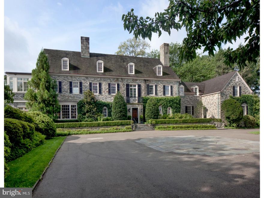 Originally the estate home of E.Fenimore Johnson this magnificent Stone Manor home and adjacent Carriage house stand as one of the Main Lines true landmark properties having sheltered only 2 families in its rich 75 year history.   Set on almost 6 acres of land and ringed by additional conserved grounds, the home was comprehensively renovated and expanded from 2004-2006 to satisfy the demands of a modern day family while embracing the quality and scale of the original architecture.  A gated entry and arrival courtyard open to a centrally located Reception Hall.   The inviting Living Room, enhanced by a full wall of windows showcasing the rear yard, gleaming wood paneled Library and Solarium with wrap around windows and french doors to the stone terrace, enjoy a Southeastern exposure while the Dining Room, Family Room with fireplace and coffered ceiling, chef's Kitchen and Breakfast Room face towards the South and the West, providing full day sun and warm afternoon light.  A sweeping stair with overlook balcony ascends to the homes second level.  The main house offers 5 guest or family bedrooms all with ensuite baths, in addition to a romantic Master Bedroom retreat with his and her baths, Sitting Room & immense outfitted closet.  Fully finished Lower Level offers large recreation space with oversized rustic stone fireplace, gym, primary storage and mechanicals.  The recently refreshed home is unique in its ability to offer grand as well as intimate spaces on its 4 finished levels.  Exquisitely detailed, beautifully maintained and professionally appointed.  A one-of-a kind offering within the suburb of Gladwyne.