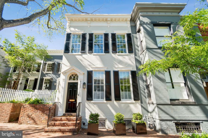 This beautifully renovated 4-bedroom, 3.5-bath Georgetown residence blends historic details with modern updates. The sun-filled front Living Room features an antique fireplace, decorative beams and moldings, and recessed lighting throughout. The formal dining room offers a double-sided fireplace, built-ins, and French doors. The chef’s kitchen, outfitted with large island, Sub-Zero and Wolf appliances, and wine storage, flows into a light-filled family room with French doors to a tiered garden with built-in grill and a large garage for storage primarily (portion of garage door opening obstructed). Upstairs, the primary suite features five closets (including two walk-ins and a dedicated shoe closet), a deep window-seat with storage under the Southern-facing light, and an original fireplace mantle. The elegant primary bath includes Waterworks and Porcher fixtures, twin pedestal sinks, and a dual-head shower. Additional bedrooms share a marble bath with skylight, and the lower level includes a media den, full bath, utility room, and a lockable wine room. The lower level is complete with large media room with a temperature controlled wine closet, laundry room, bedroom and bathroom. This exceptional home offers historic charm, premium finishes, and modern functionality in a coveted Georgetown location.