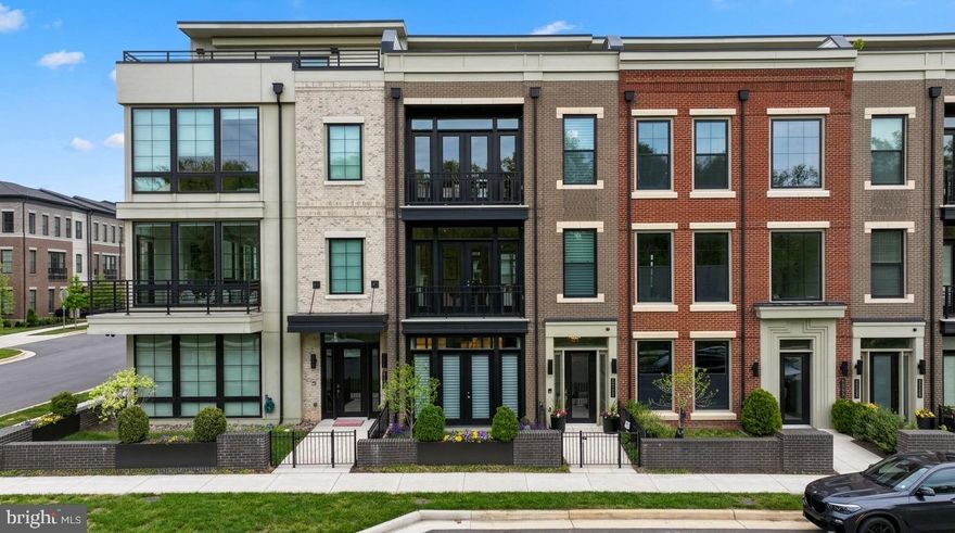 Welcome to one of One Loudoun’s most exceptional luxury townhomes—an ideal residence for those seeking to simplify without compromise. Perfectly positioned overlooking Central Park, this four-level home offers refined, turnkey living with the rare convenience of a private elevator connecting every floor. Thoughtfully designed for both everyday comfort and elegant entertaining, it delivers a seamless blend of sophistication, functionality, and effortless lifestyle.

From the moment you enter, the home sets a distinctive tone. The entry level features an expansive club room with custom built-ins and a sleek wet bar with beverage refrigeration—an inviting space for hosting or relaxing. A fully built-out personal lobby provides exceptional storage, while dual-zone wine coolers (188-bottle capacity) offer a striking introduction to the level of detail found throughout.

The main living level is a true showpiece, anchored by a chef-caliber kitchen designed to rival the finest custom homes. An oversized island, premium Wolf and Sub-Zero appliances—including a six-burner double oven range, convection steam oven, and dedicated wine tower—combine performance with striking design. Custom cabinetry, integrated lighting, and a designer backsplash complete the space. The sunlit dining and family rooms overlook Central Park, with a Juliet balcony enhancing the open feel. At the rear, a more intimate hearth room with gas fireplace opens directly to a private deck, creating a warm and versatile living environment.

The bedroom level offers a serene retreat. The primary suite features custom-designed closets and a private balcony with peaceful park views. The spa-inspired bath includes heated floors, a walk-in shower, soaking tub, and elevated finishes throughout. Two additional bedrooms share a well-appointed bath, and a thoughtfully designed laundry room with custom built-ins adds convenience without sacrificing style.

The top level is dedicated to elevated living and entertaining. A spacious recreation room with built-in surround sound is complemented by an impressive bar with refrigeration, creating an ideal gathering space. Step out to the expansive rooftop terrace, where a natural gas firepit and multiple seating and dining areas overlook the park—perfect for both relaxed evenings and larger gatherings. A fourth bedroom, full bath, and additional storage complete this level.

What truly sets this home apart is its effortless, lock-and-leave lifestyle. With minimal exterior maintenance, elevator access to all levels, and fully integrated Control4 smart home technology for lighting, audio, and shades, every detail is designed for ease and comfort—whether at home or away.

Located in the heart of One Loudoun, this residence offers unmatched walkability to premier dining, shopping, and entertainment. With convenient access to major routes, Washington Dulles International Airport, and Inova Loudoun Hospital just minutes away, it provides both connectivity and peace of mind.

For those transitioning from larger homes or seeking a refined, low-maintenance lifestyle without sacrificing quality or space, this is a rare opportunity to enjoy luxury living in one of Northern Virginia’s most vibrant communities.

This home truly has it all—don’t miss your opportunity to make it yours.